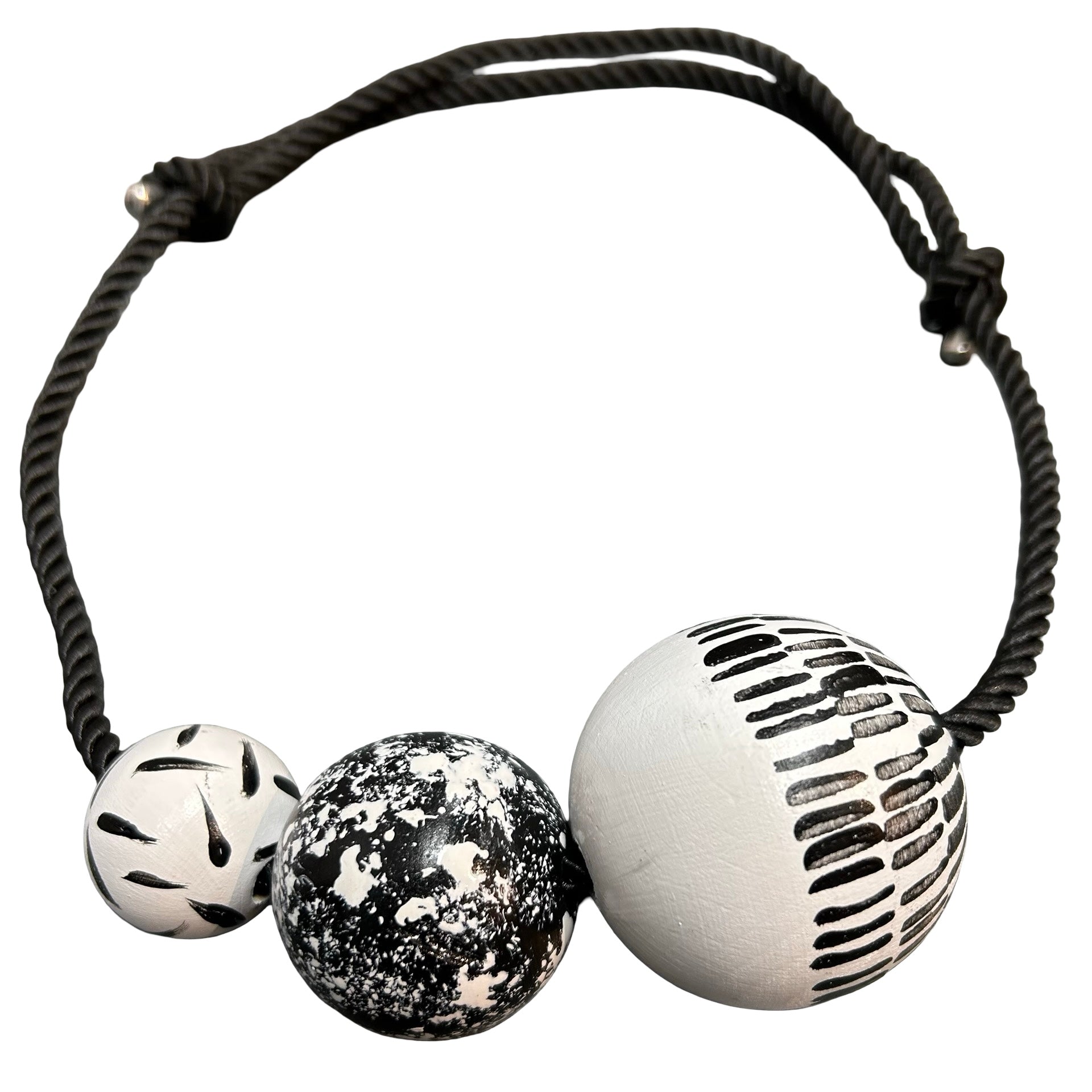 Necklace with three unique beads on a white background.