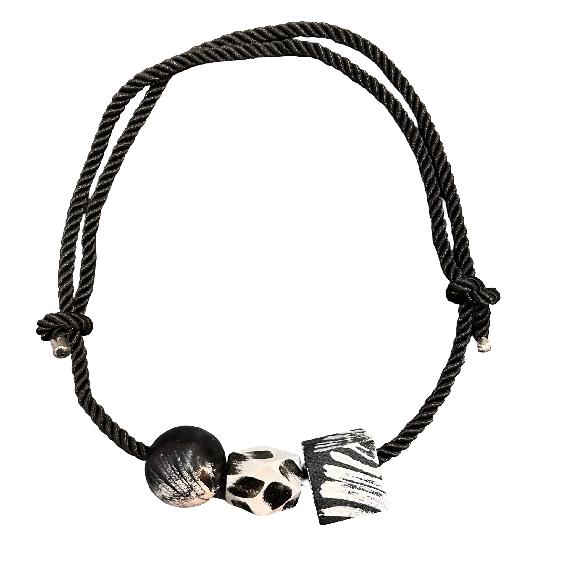 Black braided bracelet with decorative beads on a white background.