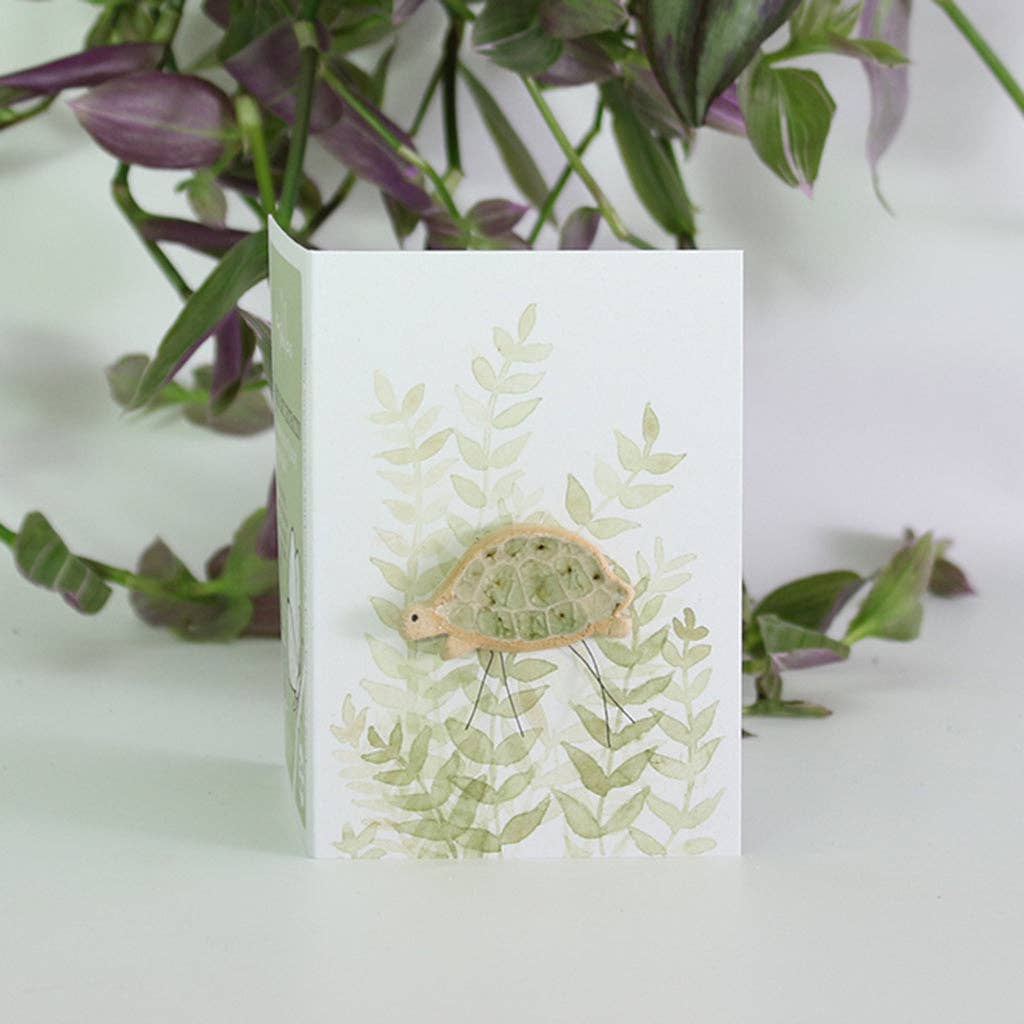 Tortoise plant hugger handmade using British clay and recycled glass.