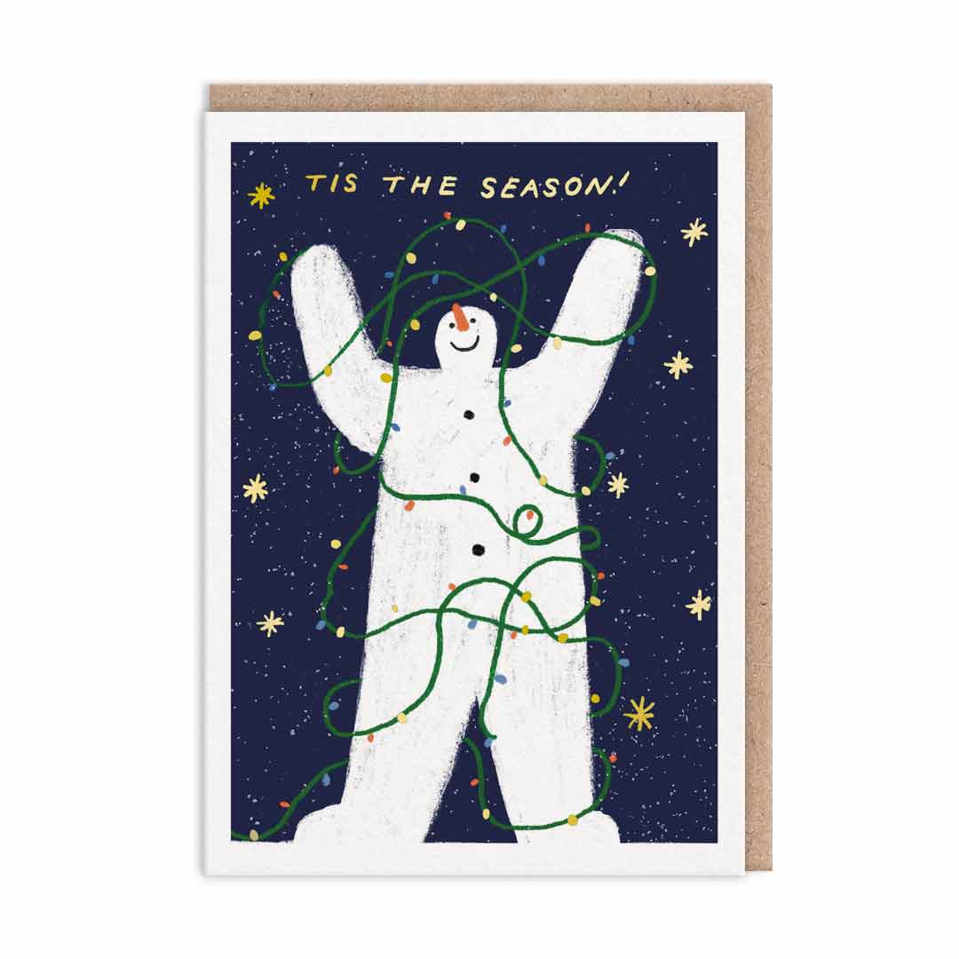 Christmas card featuring a dancing snowman wrapped in green fairy lights, complete with the text 'Tis the Season'.