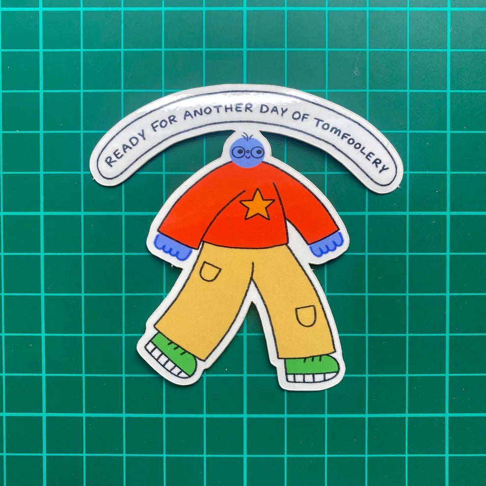 Cartoon character with red shirt and yellow pants on a green grid background.