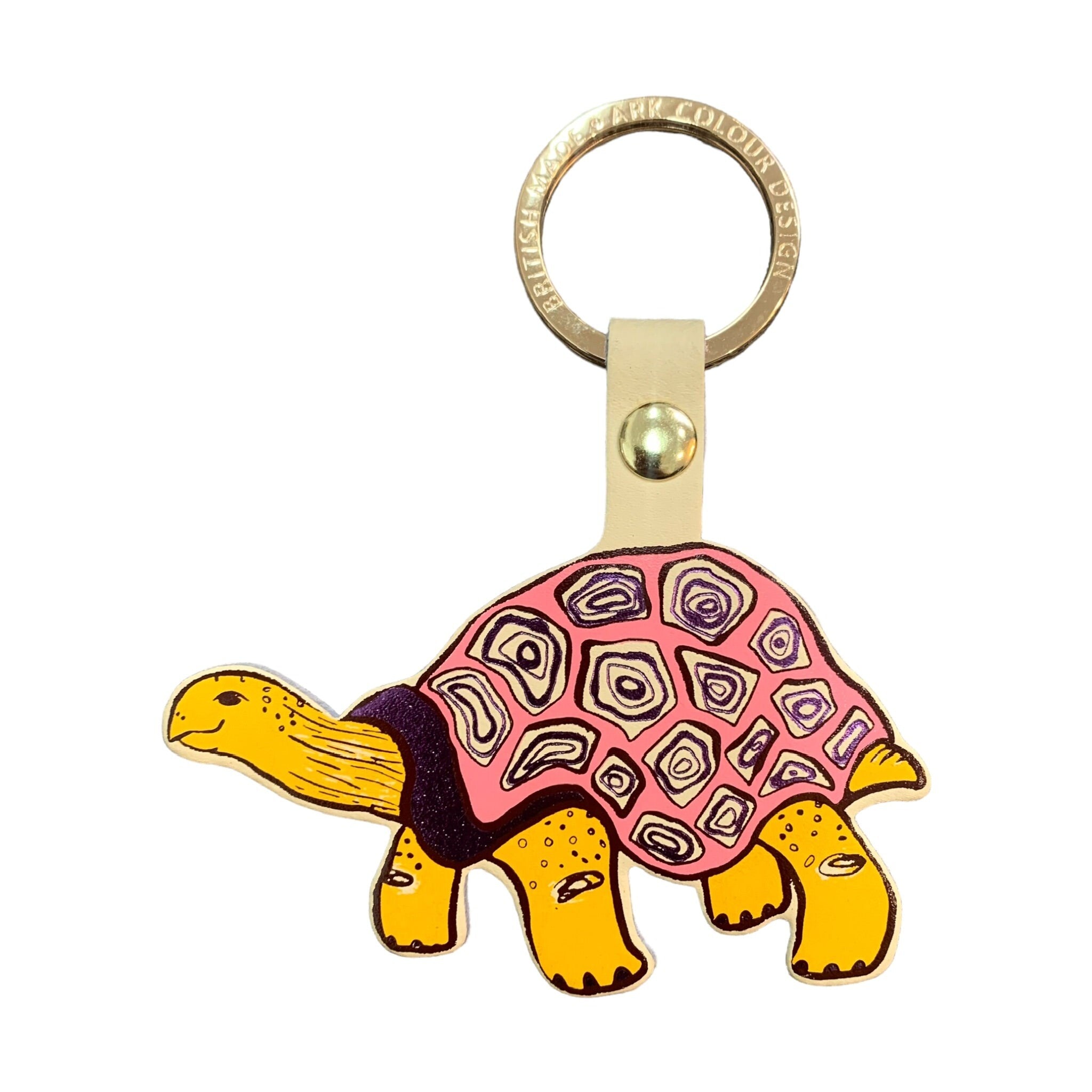 A tortoise-shaped leather keyring with a cream band, yellow tortoise and pink tortoiseshell and a gold-plated ring.