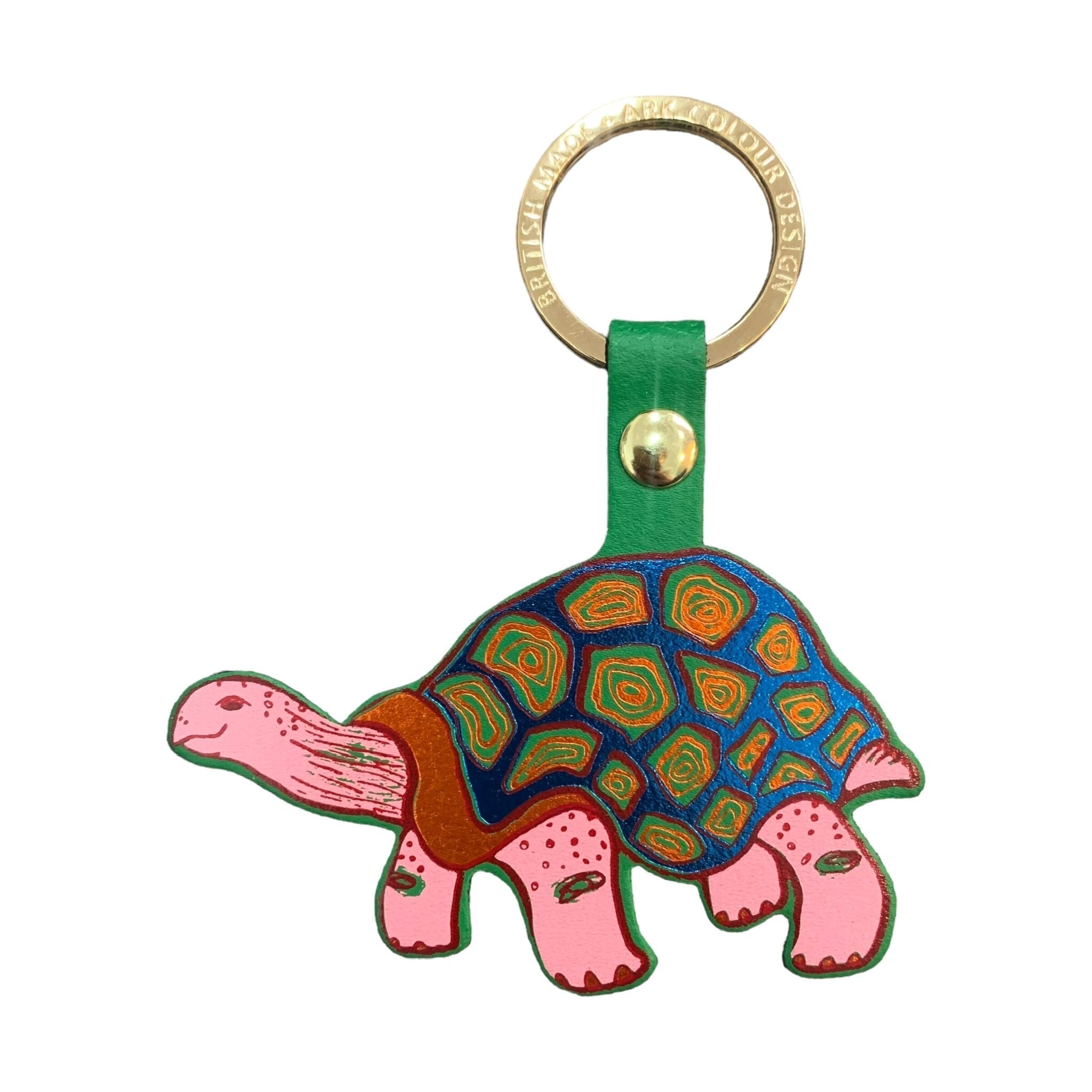 A tortoise-shaped leather keyring with a green band, pink tortoise and blue tortoiseshell and a gold-plated ring.