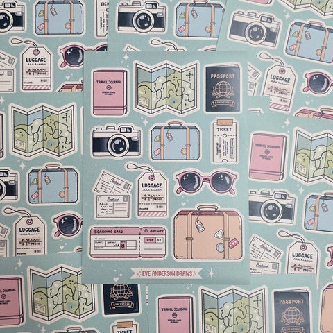 This travel-themed sticker sheet features 11 individual stickers, including a passport, a camera, a boarding pass, a pair of sunglasses, 2 suitcases and a luggage tag against a pale green background.