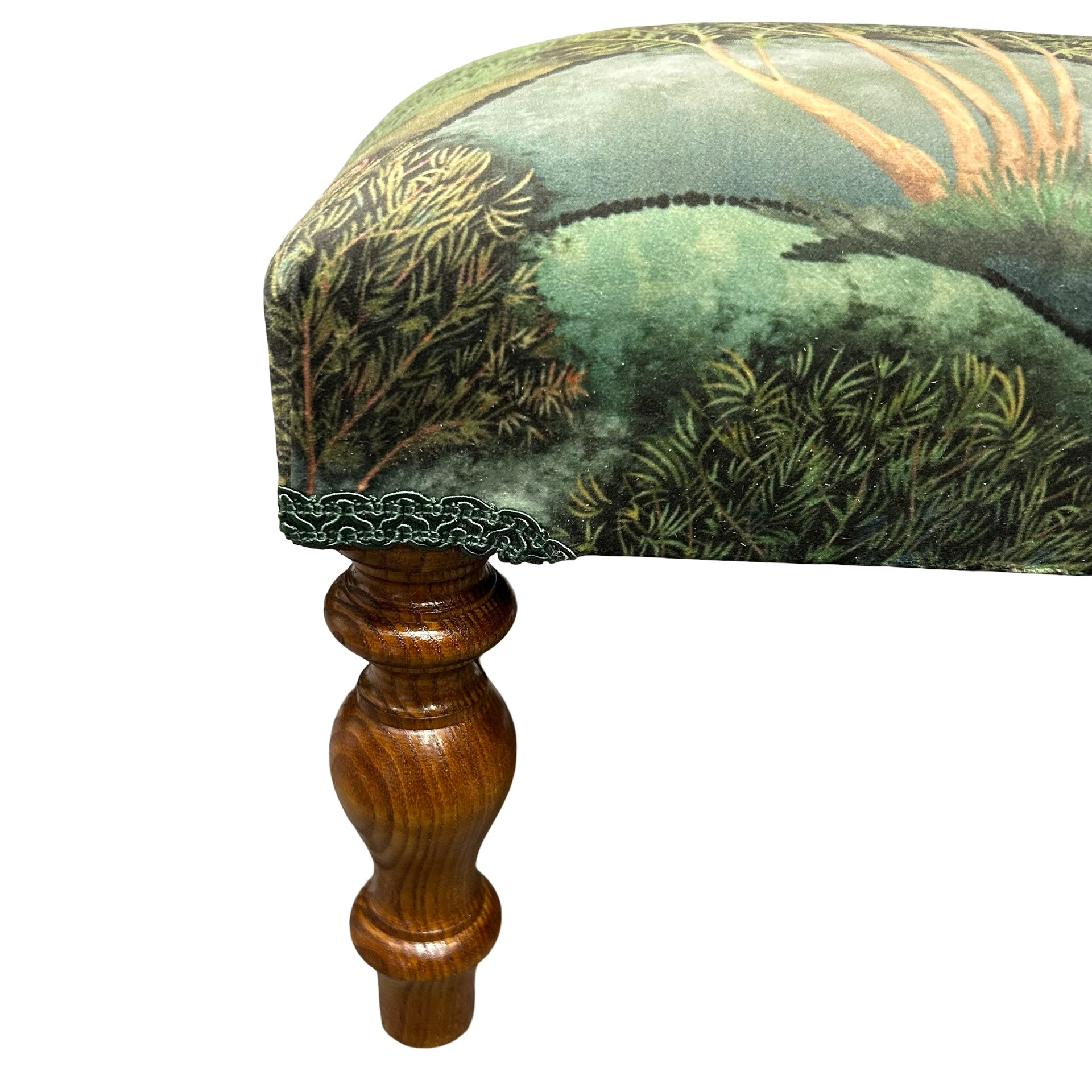 Decorative stool with green patterned fabric and wooden leg on a white background.