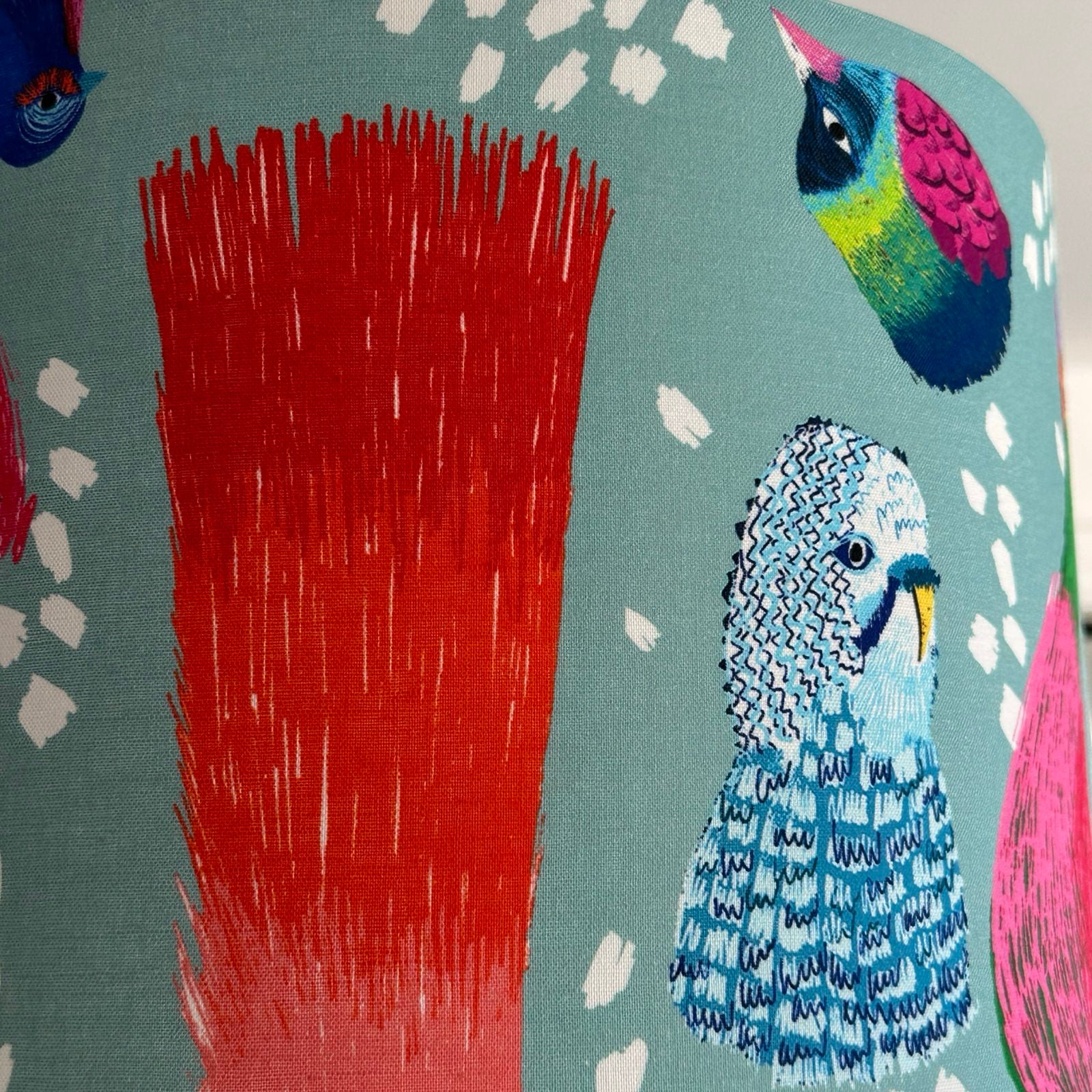 Colourful bird illustration on a lampshade.