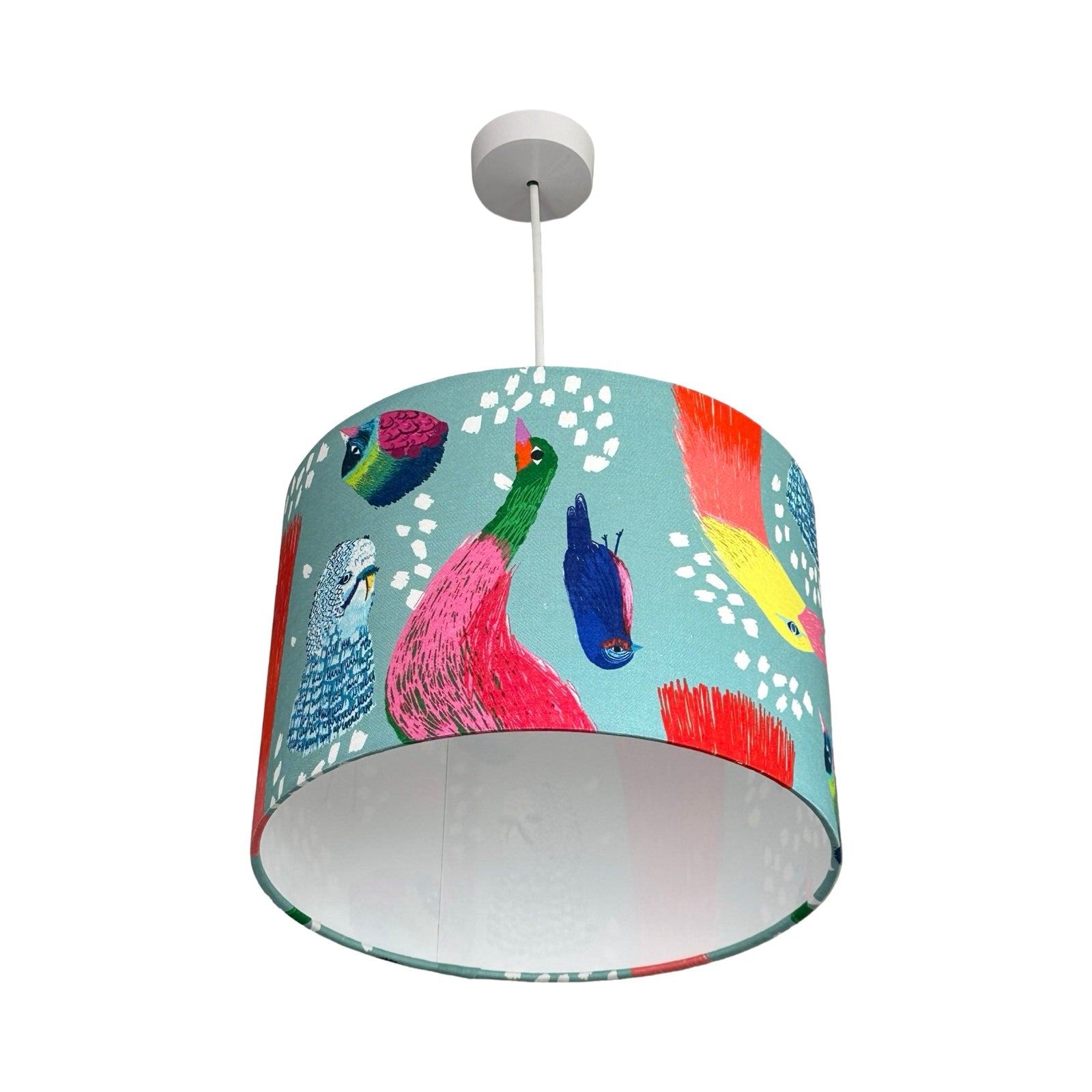 Colorful lampshade with bird design on a white background.