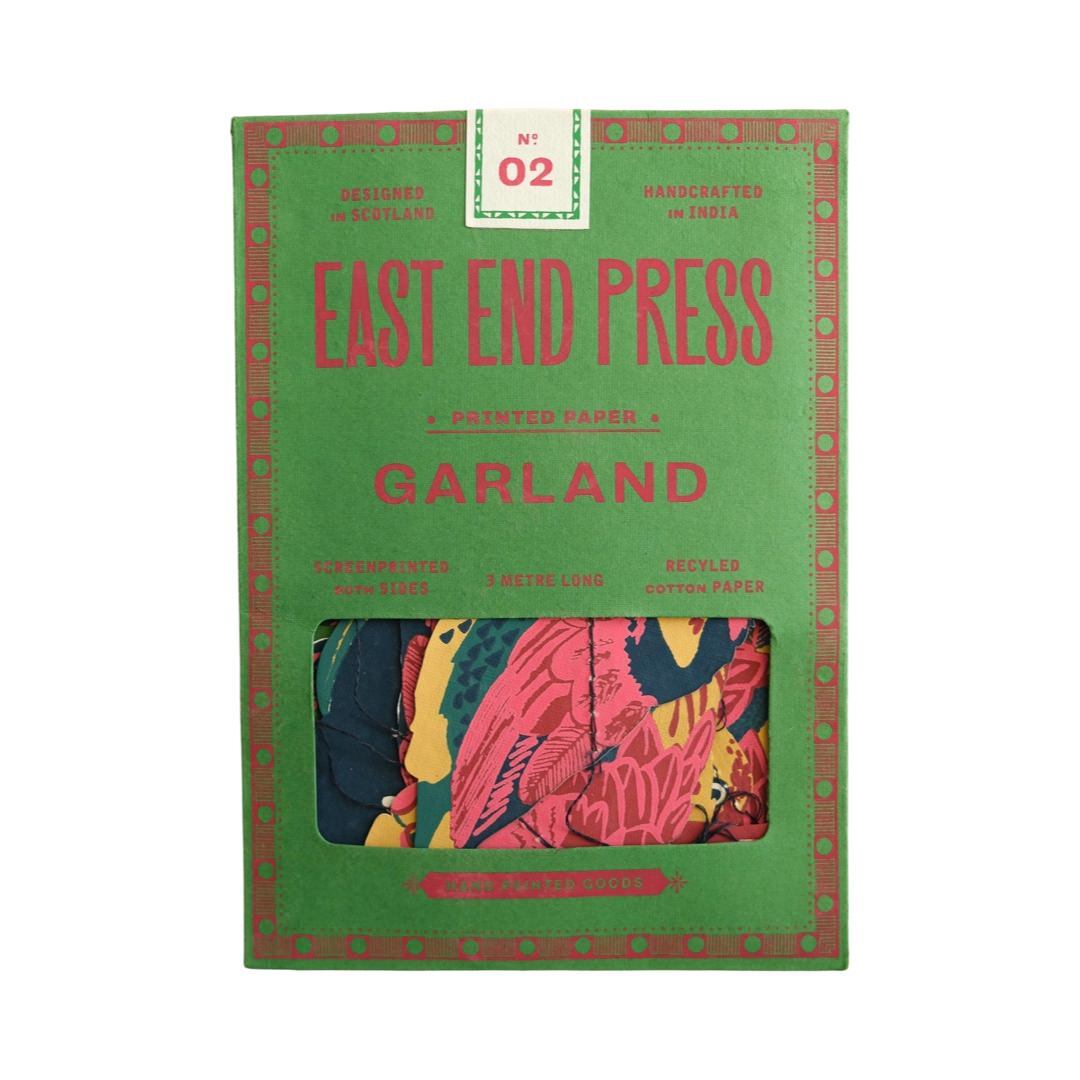 A green rectangular paper packet for a tropical birds paper garland.
