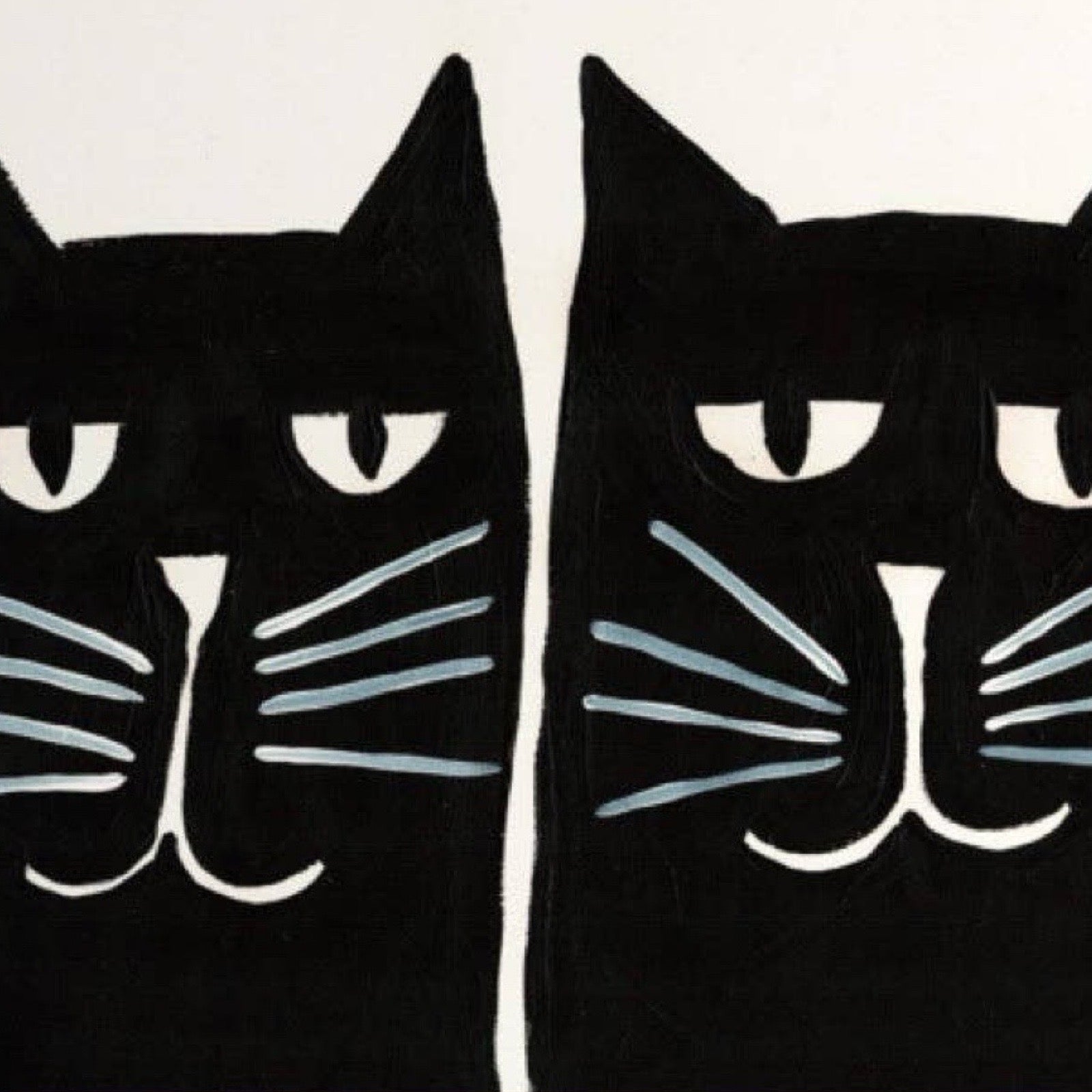 Two black cats with white faces on a beige background.