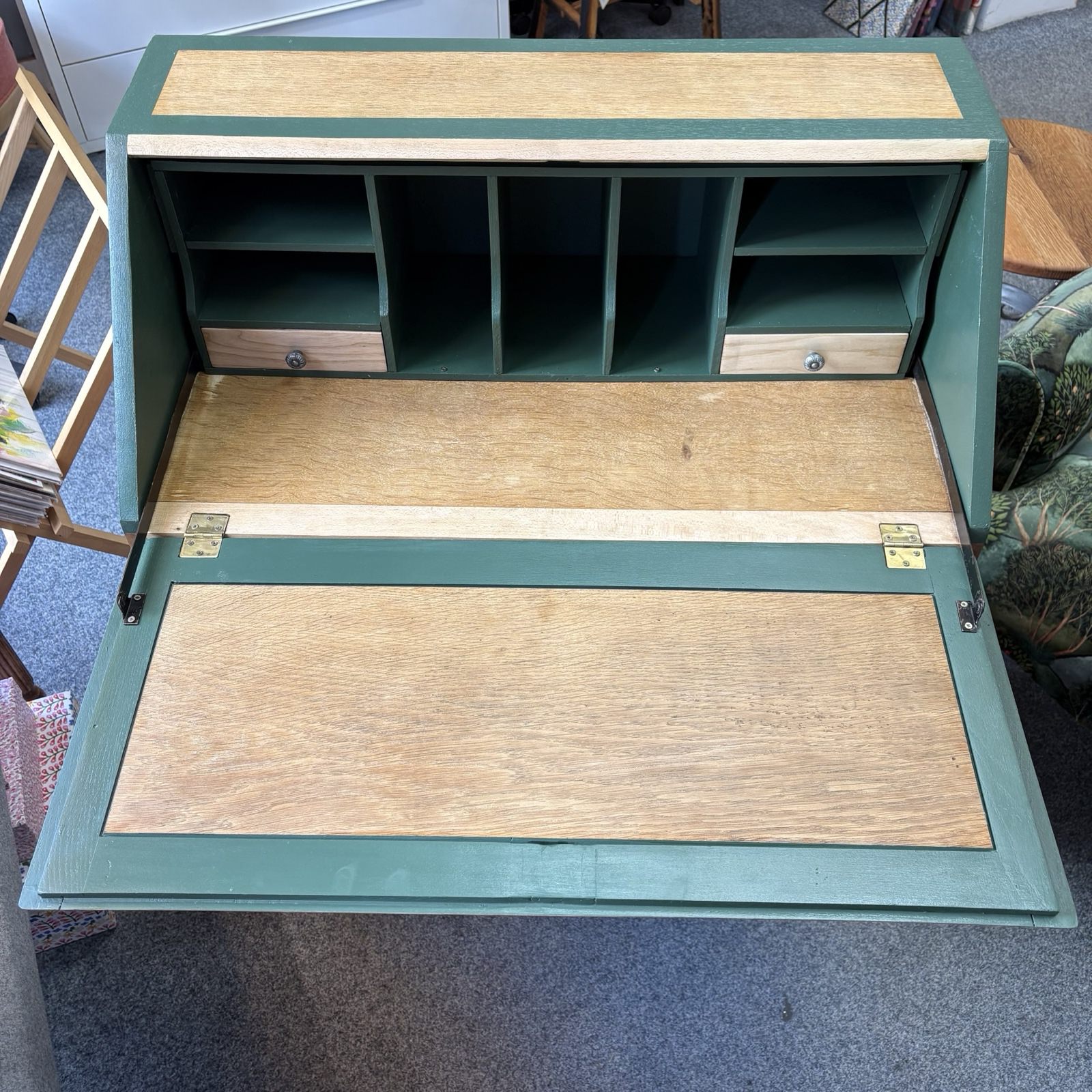 Green wooden desk with pull-out wooden flap.