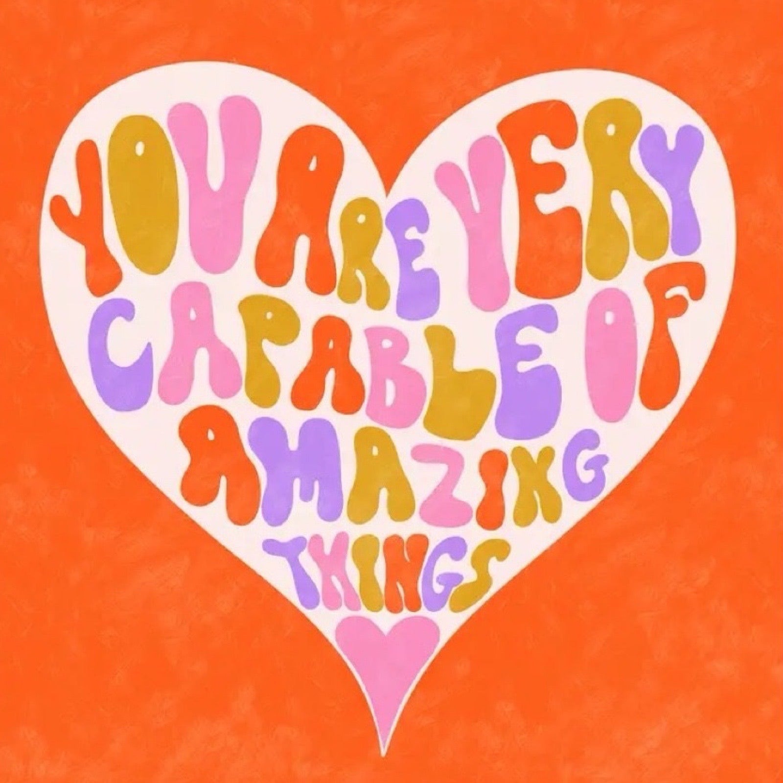 Motivational quote 'You are very capable of amazing things' in colourful letters on a heart shape with an orange background.
