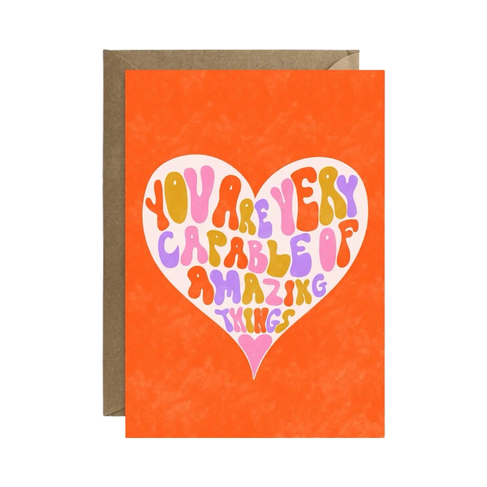 Card featuring the text 'You are very capable of amazing things' written in multicoloured lettering inside a cream love heart against an orange background.