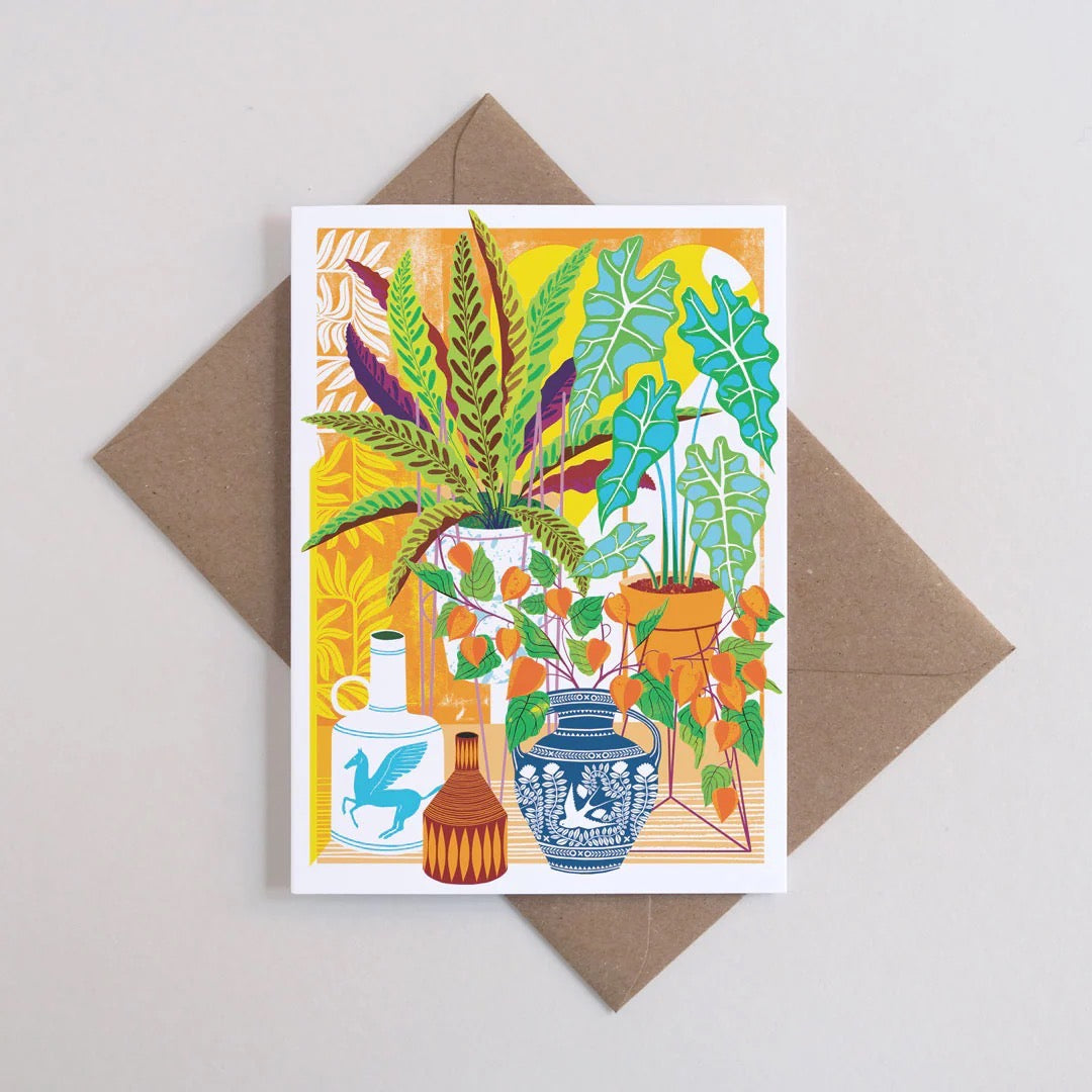 Greeting card with plant illustration next to a brown envelope.