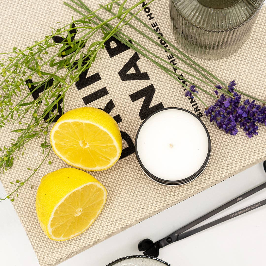 Candle with lemons and lavender on a decorative mat