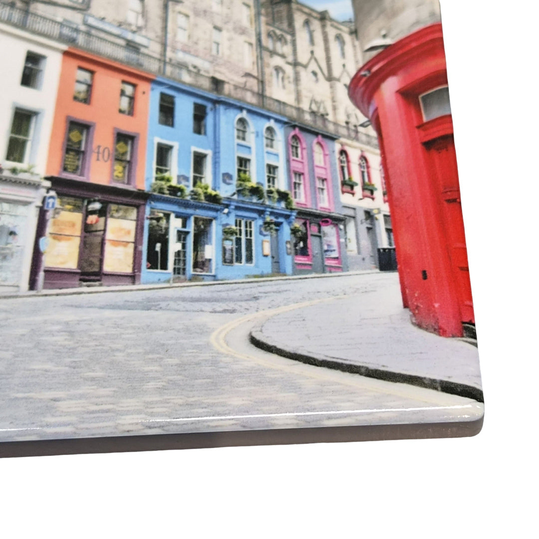 Colorful buildings on a city street on a tile coaster. 