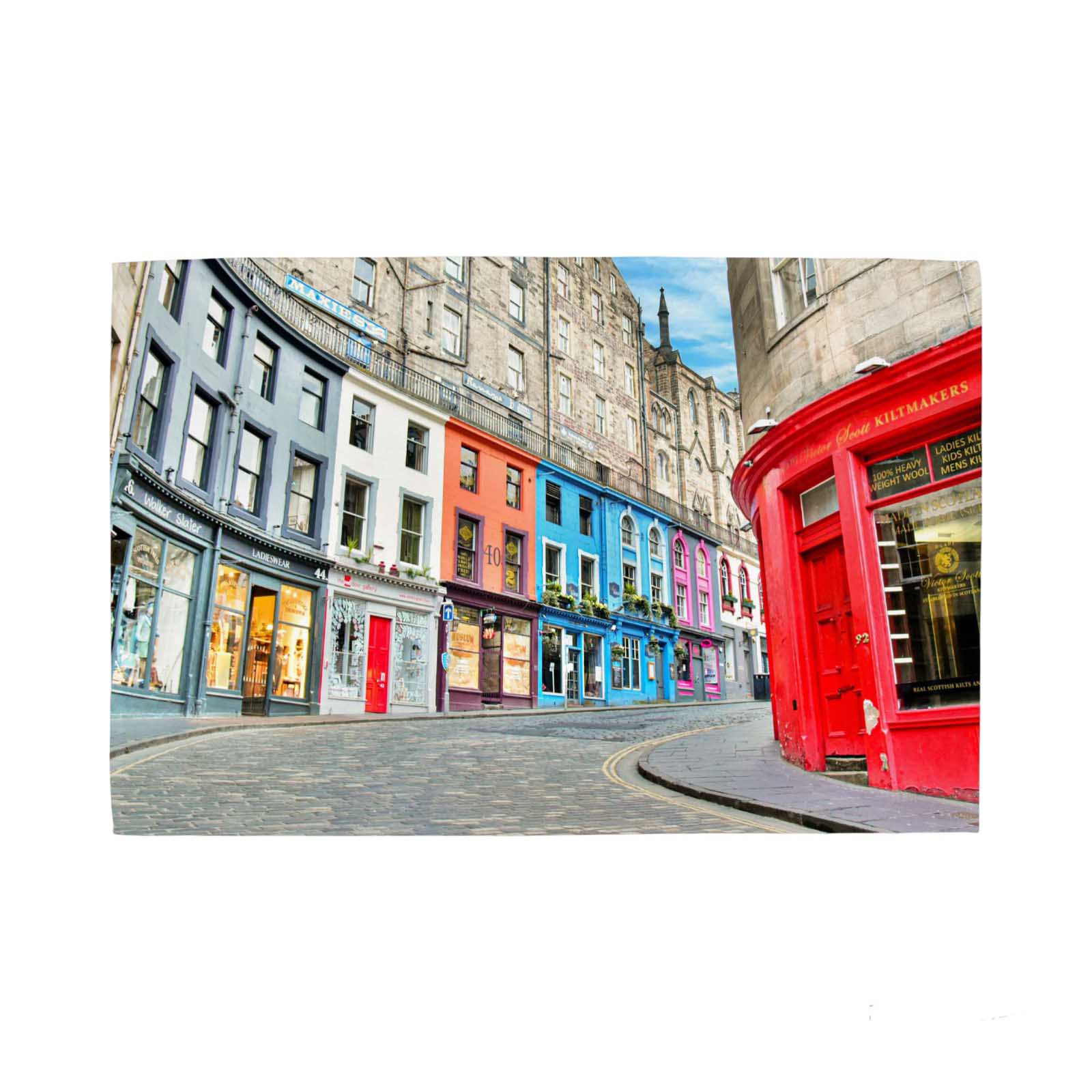 Colorful street scene of Victoria Street Edinburgh on a tea towel against a white background. 