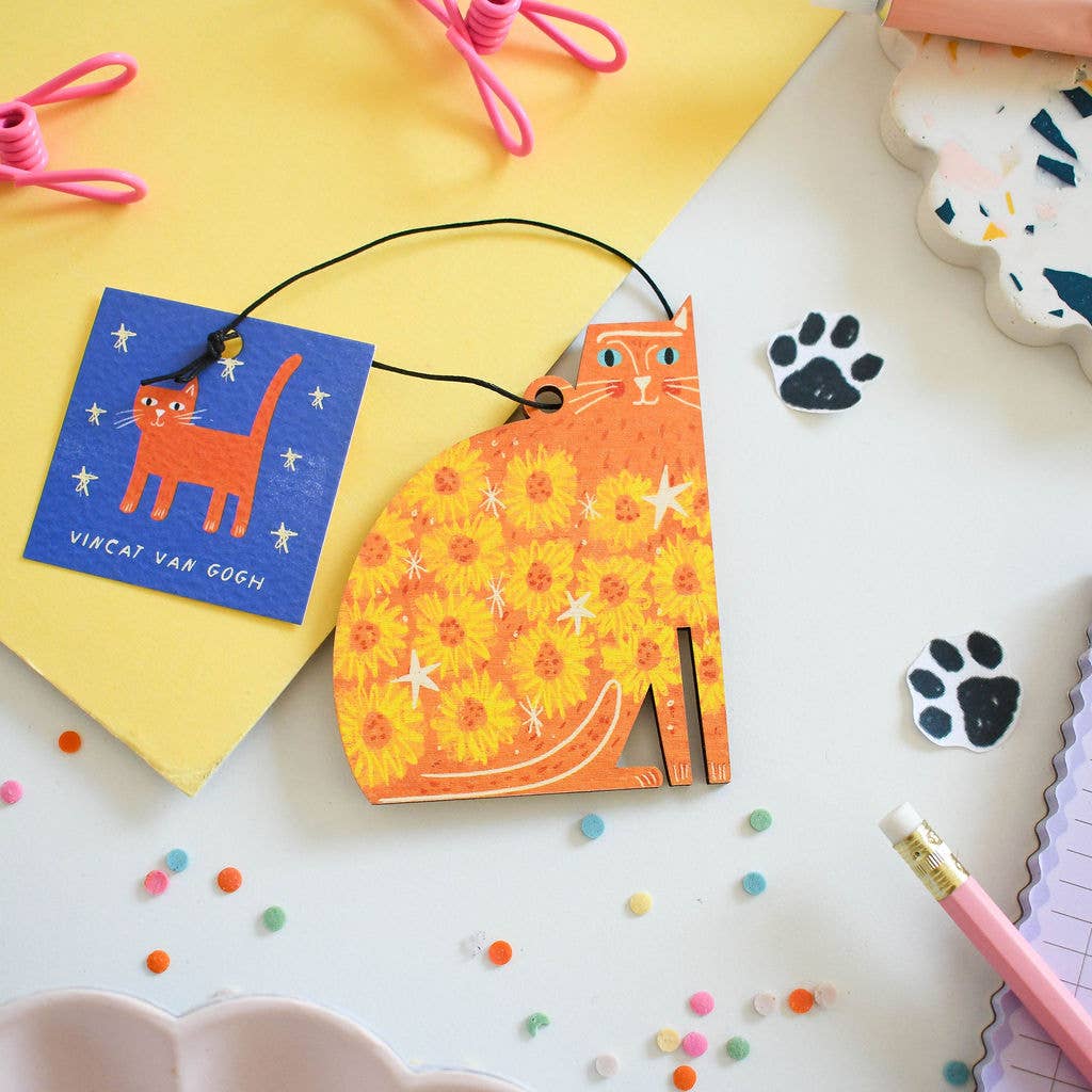 Colorful cat-themed product on a white surface with decorative elements.