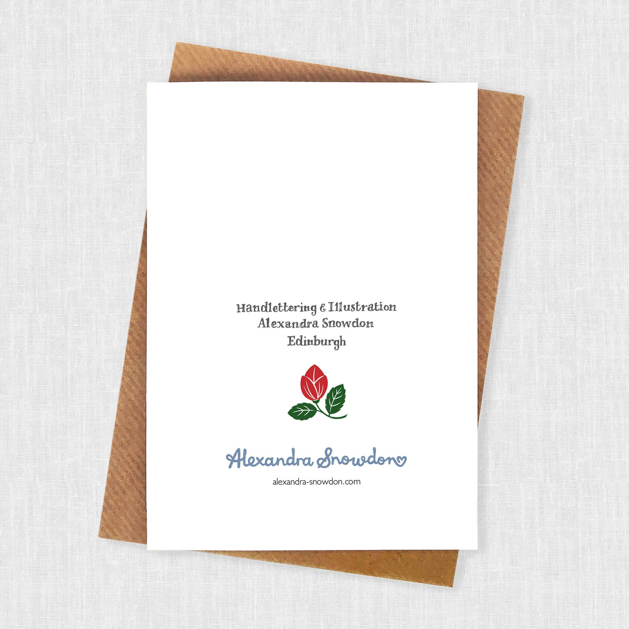 White card with brown envelope on a textured white background.
