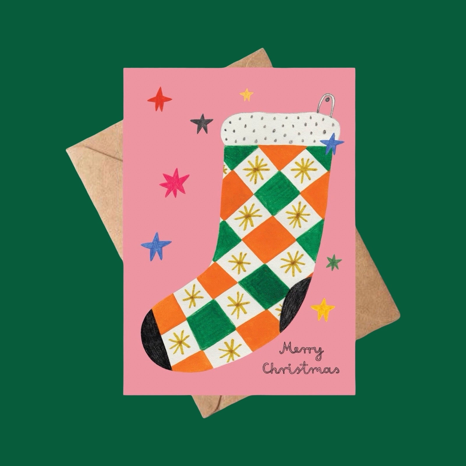 Christmas card with a colourful checkered stocking on a pink background, featuring stars and the text 'Merry Christmas', on a dark green background.