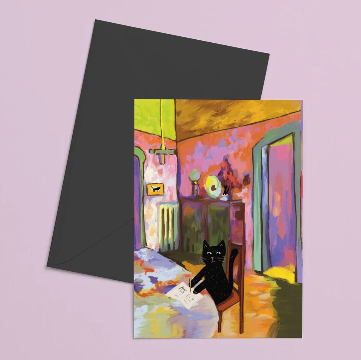 Greeting card with a colorful painting of a black cat sitting on a chair, featuring a black envelope.