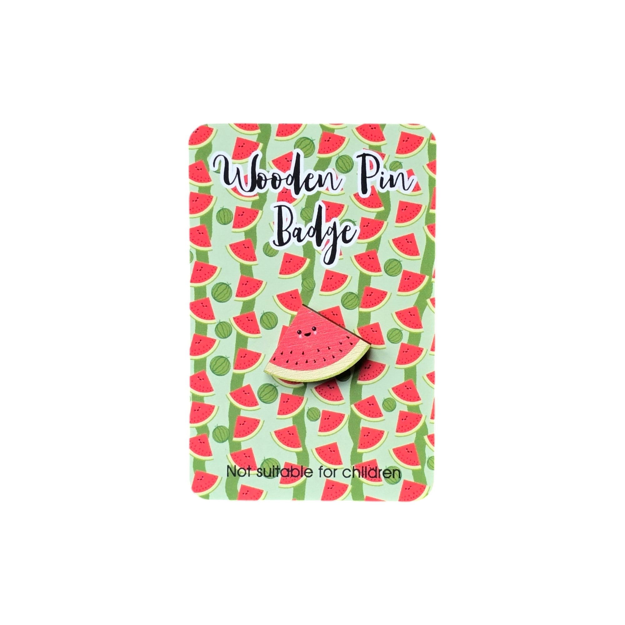 A water melon pin badge with a smiley face on backing card with a watermelon design.