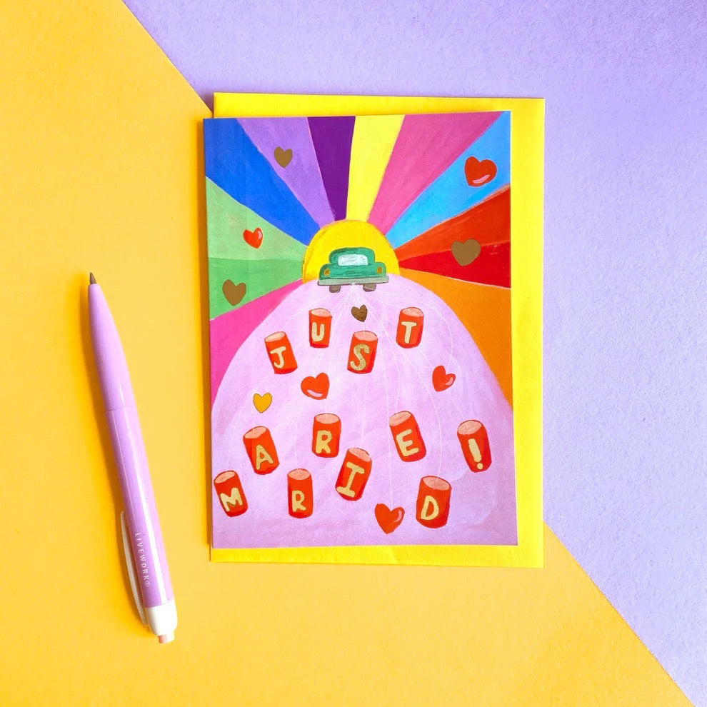 Colorful greeting card with a car and 'Just Married' text on a yellow and purple background.