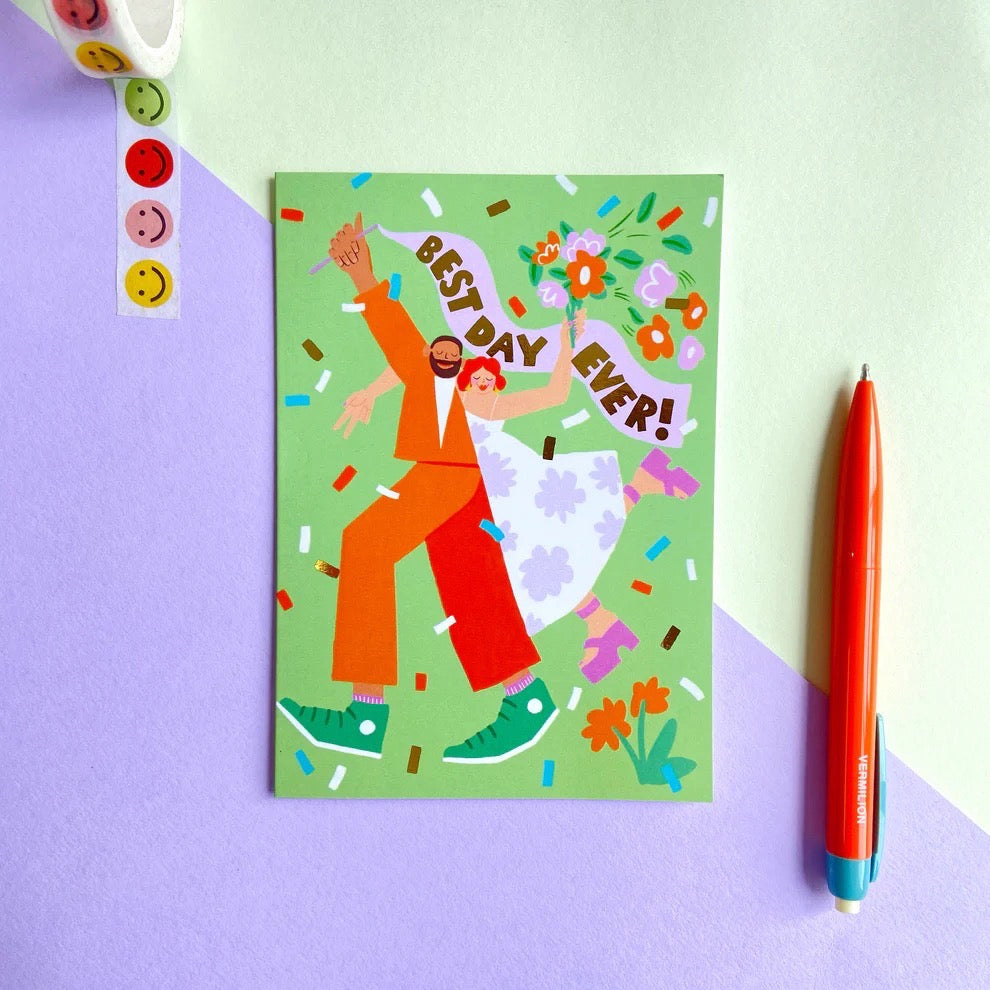 Wedding card featuring a bride (in a white dress with lilac flowers) and groom (in an orange suit) with a 'Best Day Ever' banner, on a green background with colourful confetti.