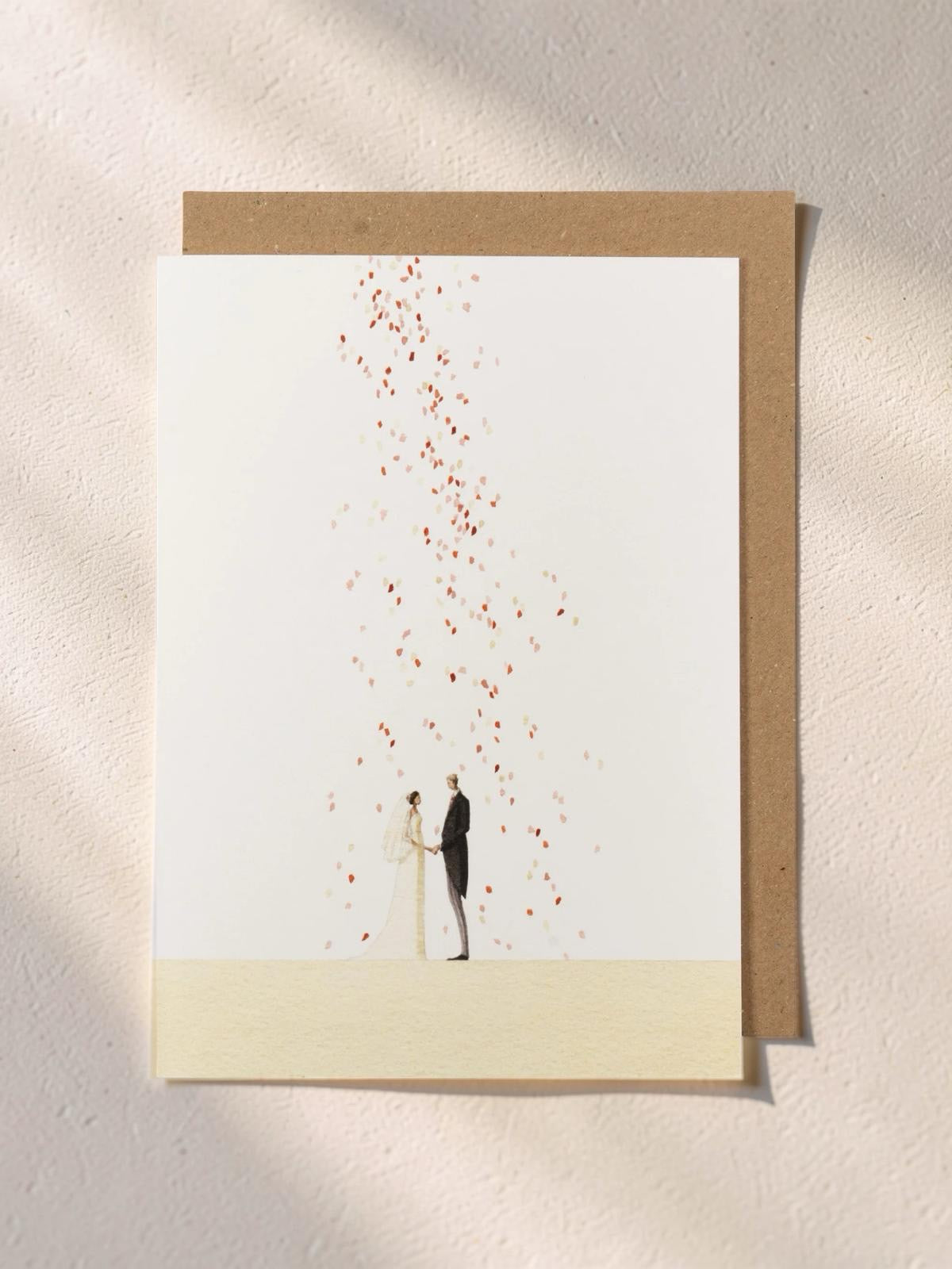 Greeting card with illustration of a couple releasing balloons on a beige background.