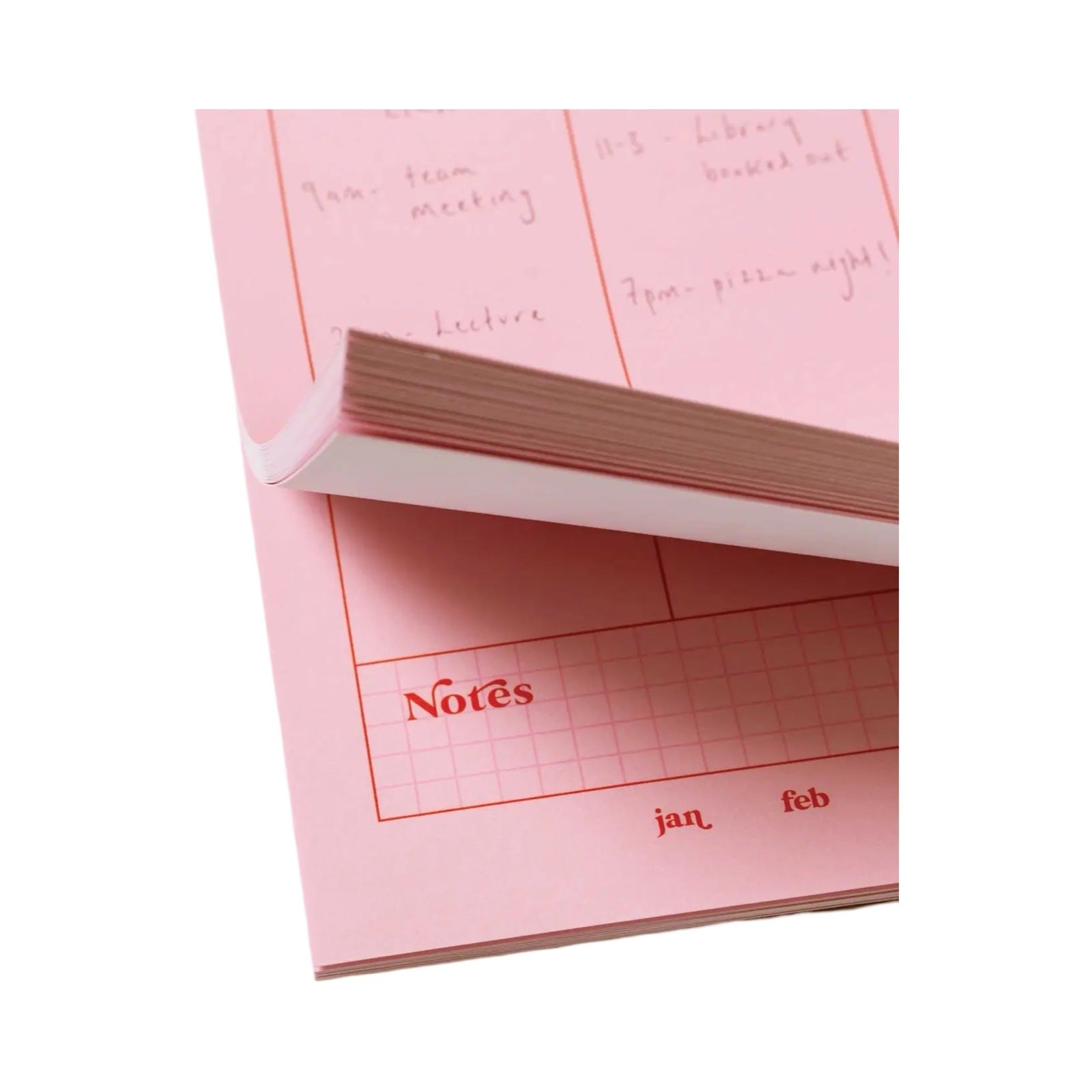 Weekly planner pad in pink and red close up.