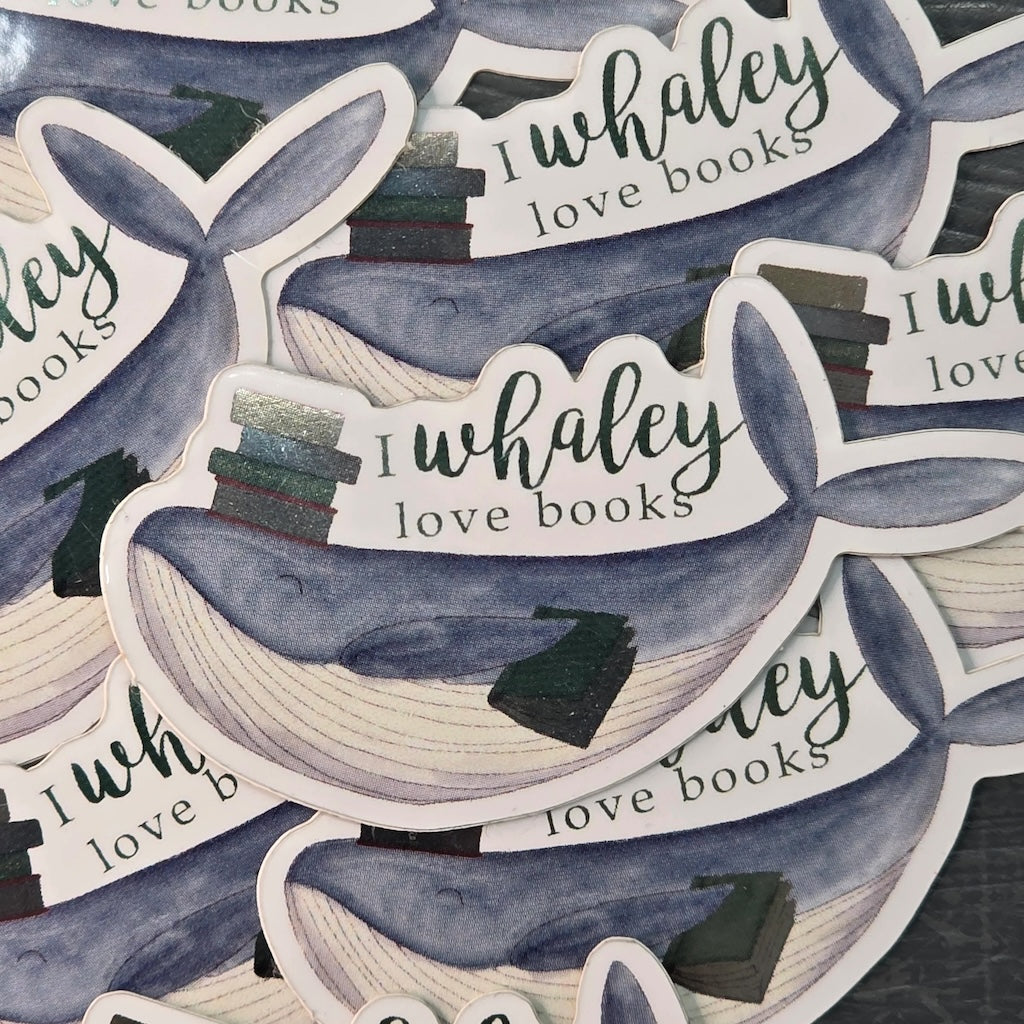 A water-resistant vinyl sticker of a whale with books on its head and the text 'I Whaley Love Books'.