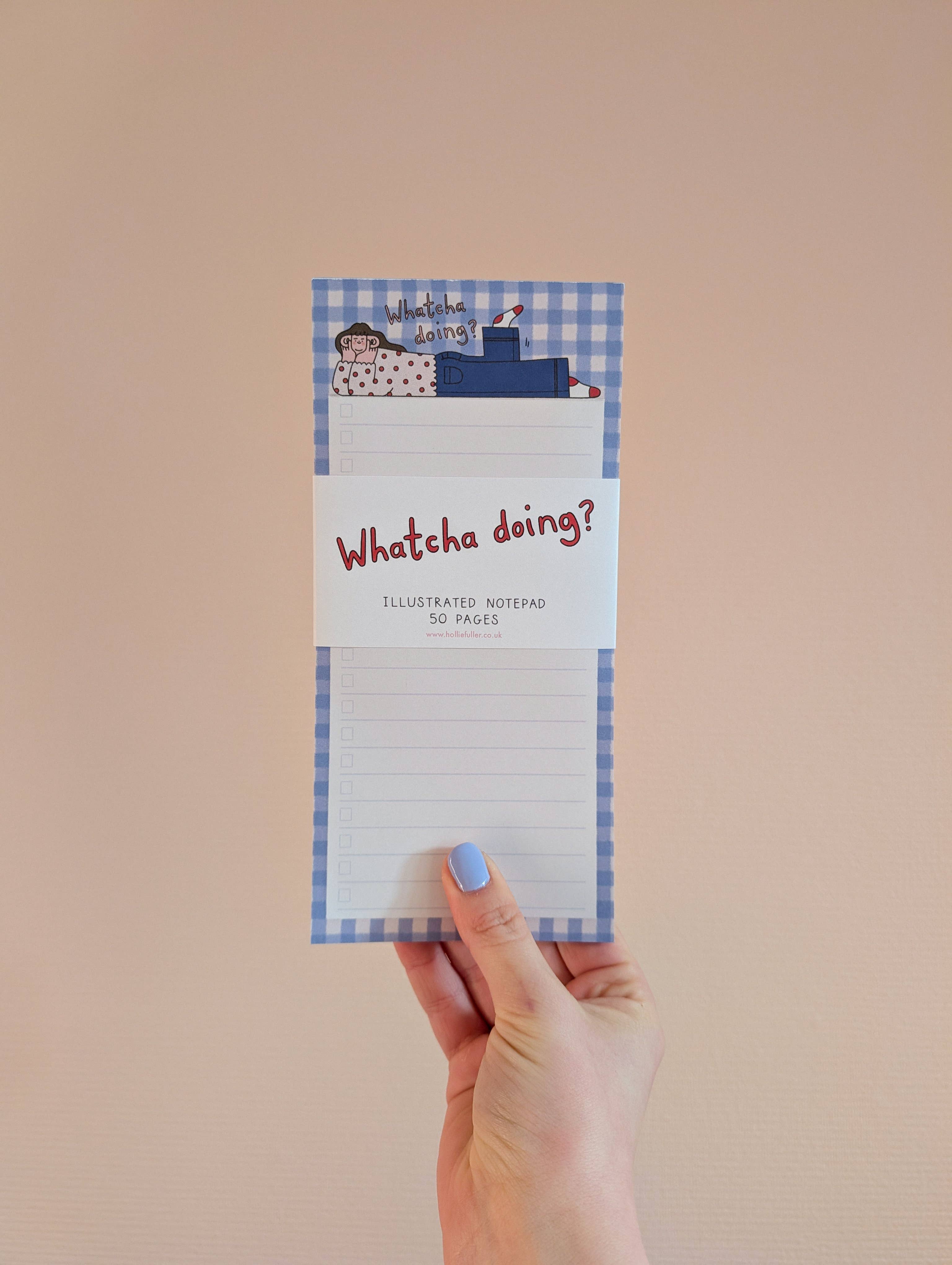 Hand holding a notepad with 'Whatcha doing?' text against a beige background.
