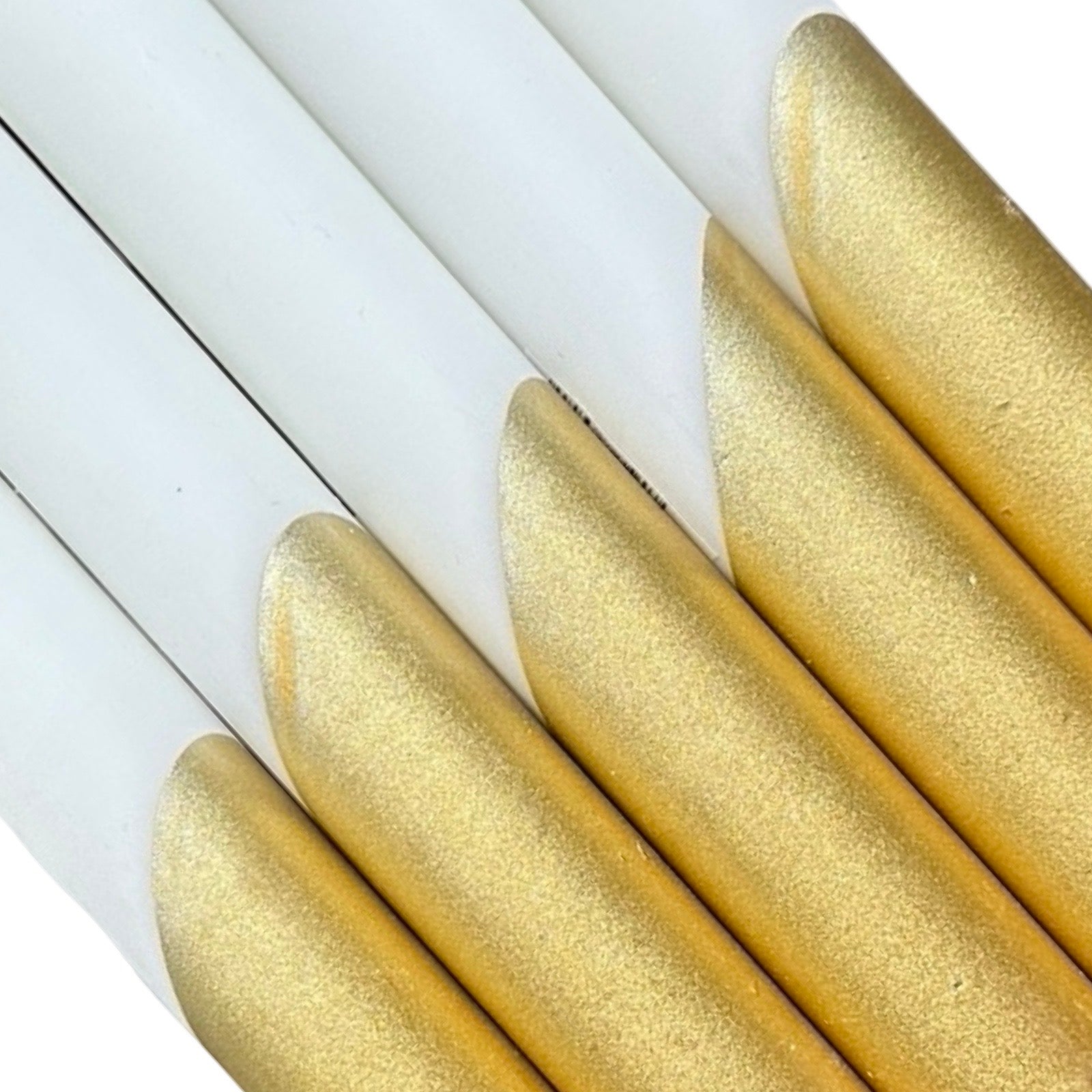 A row of 5 handmade dinner candle in white dipped in gold handcrafted from 100% stearin.