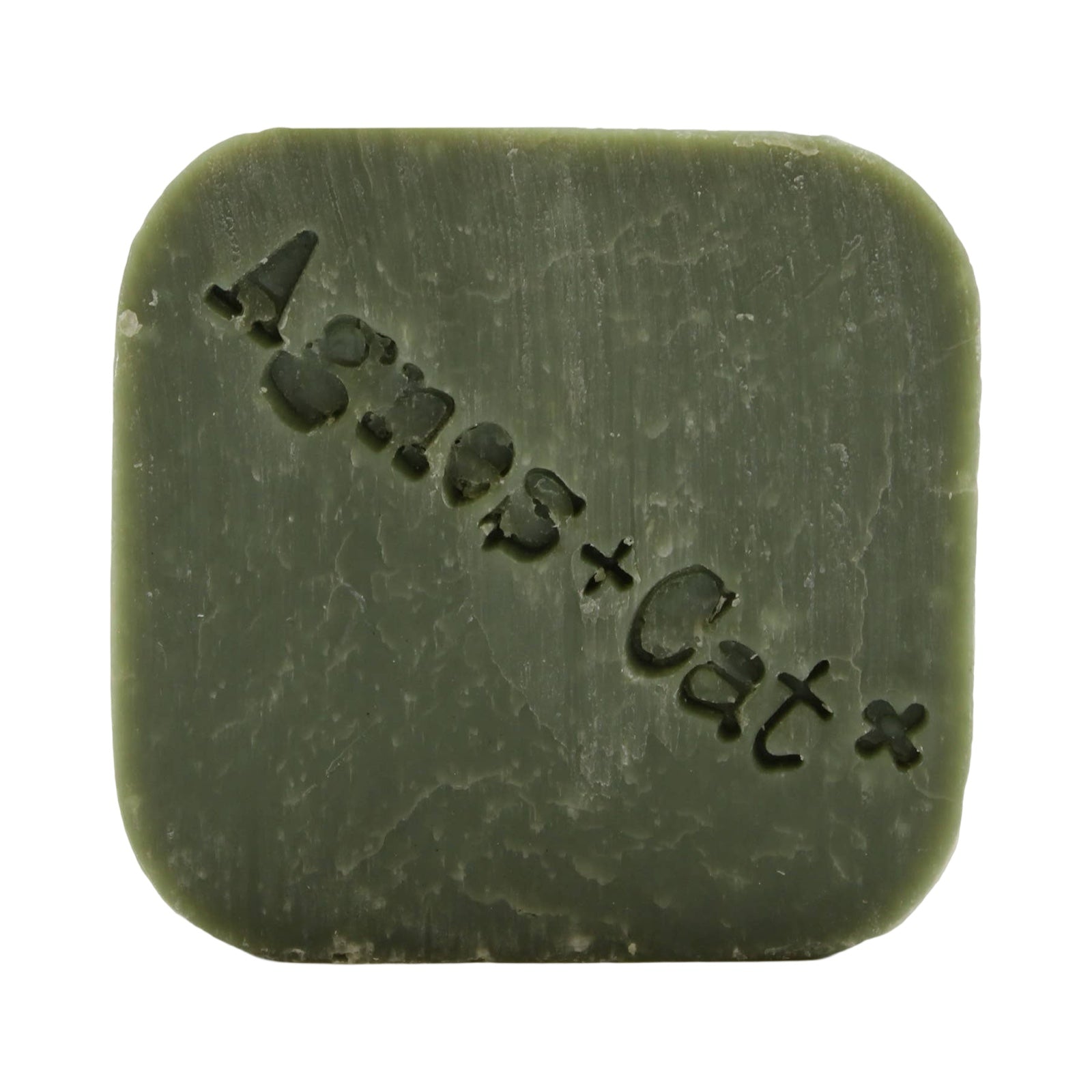 A square-shaped green, white fig scented dry shampoo bar.