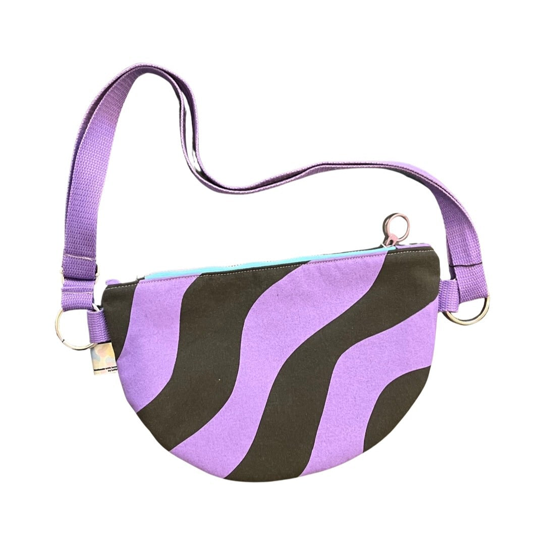 Purple and grey wiggle cross-body bag with adjustable strap.