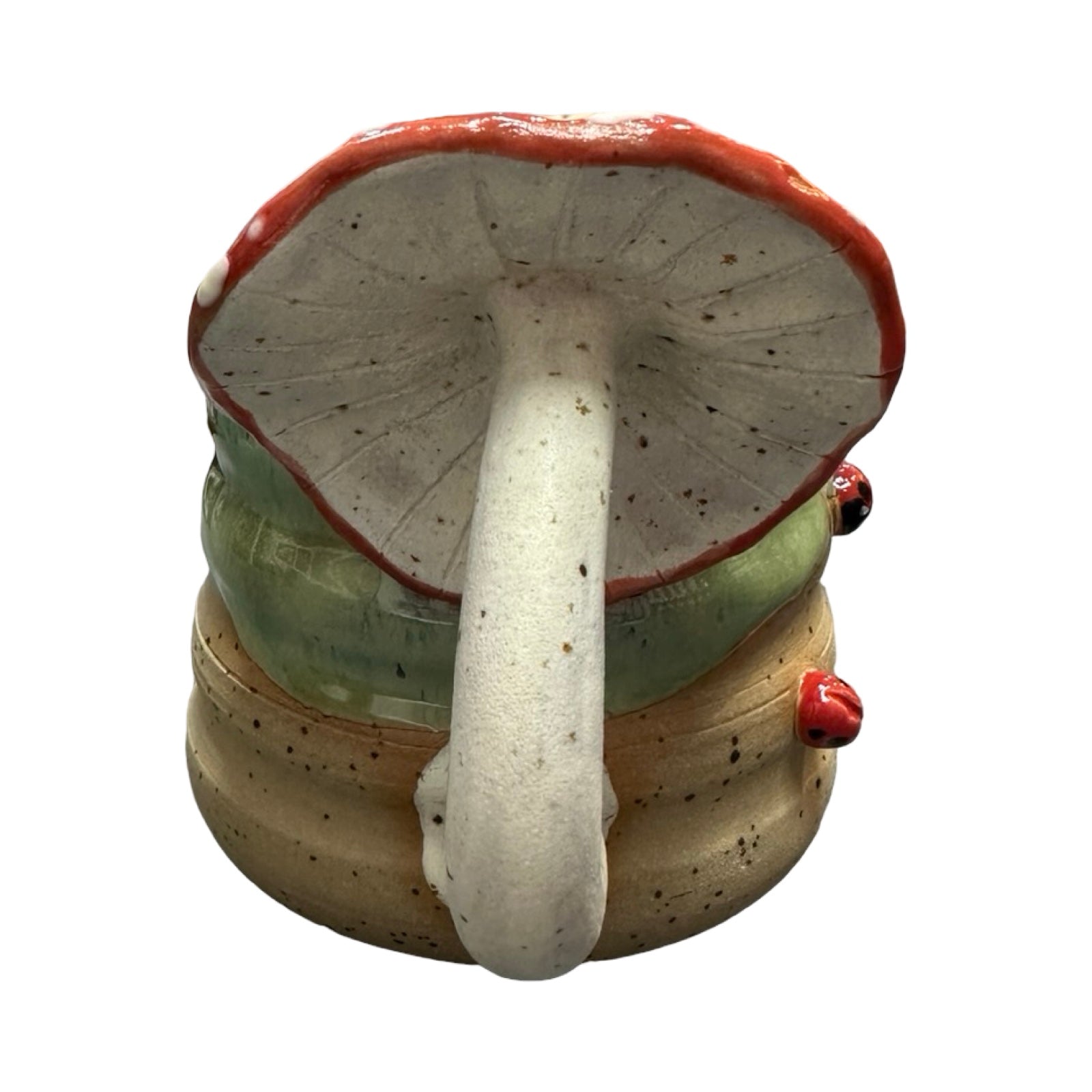 Ceramic mushroom-shaped handle on a mug on a white background.