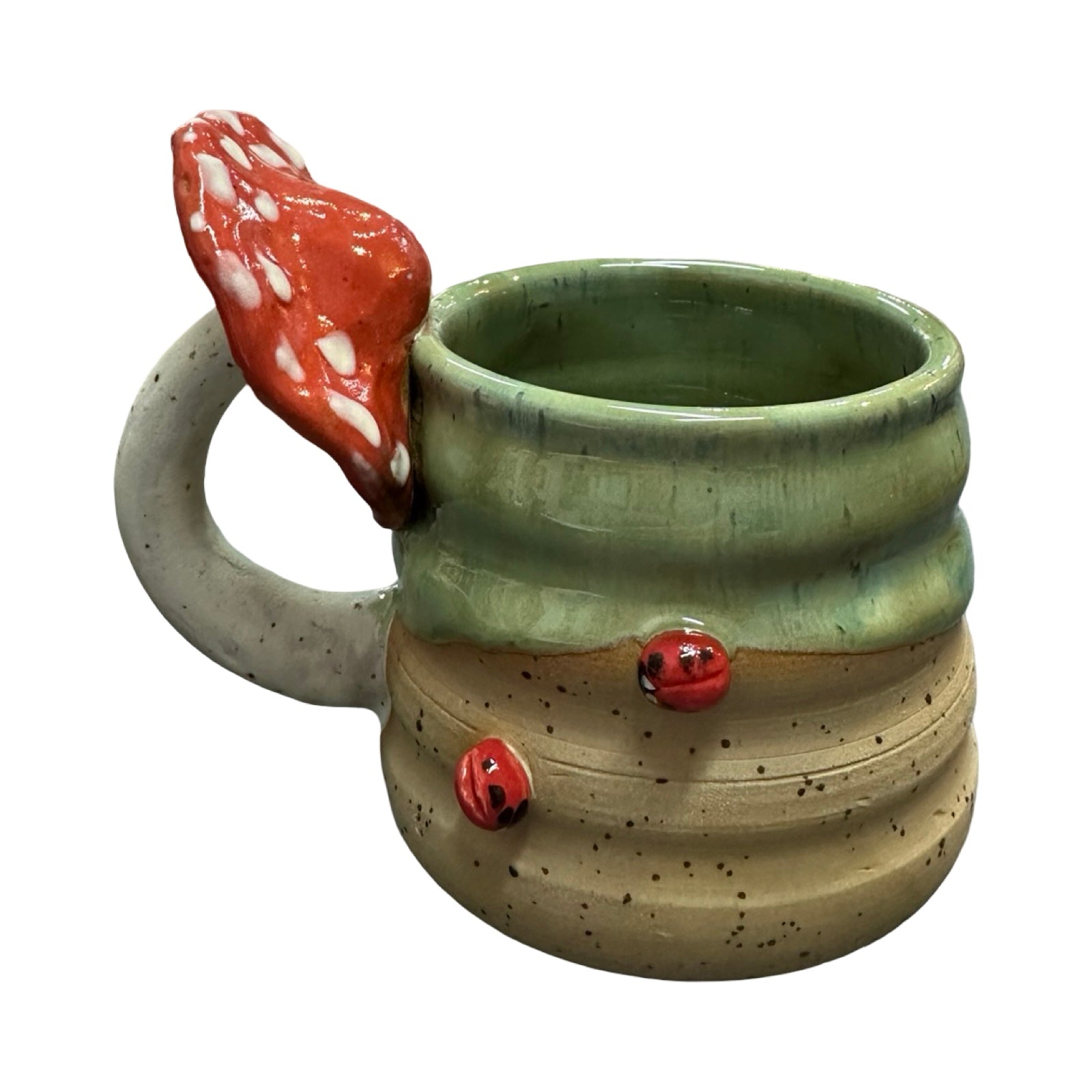 Ceramic mug with a red ladybird design and a mushroom handle on a white background.