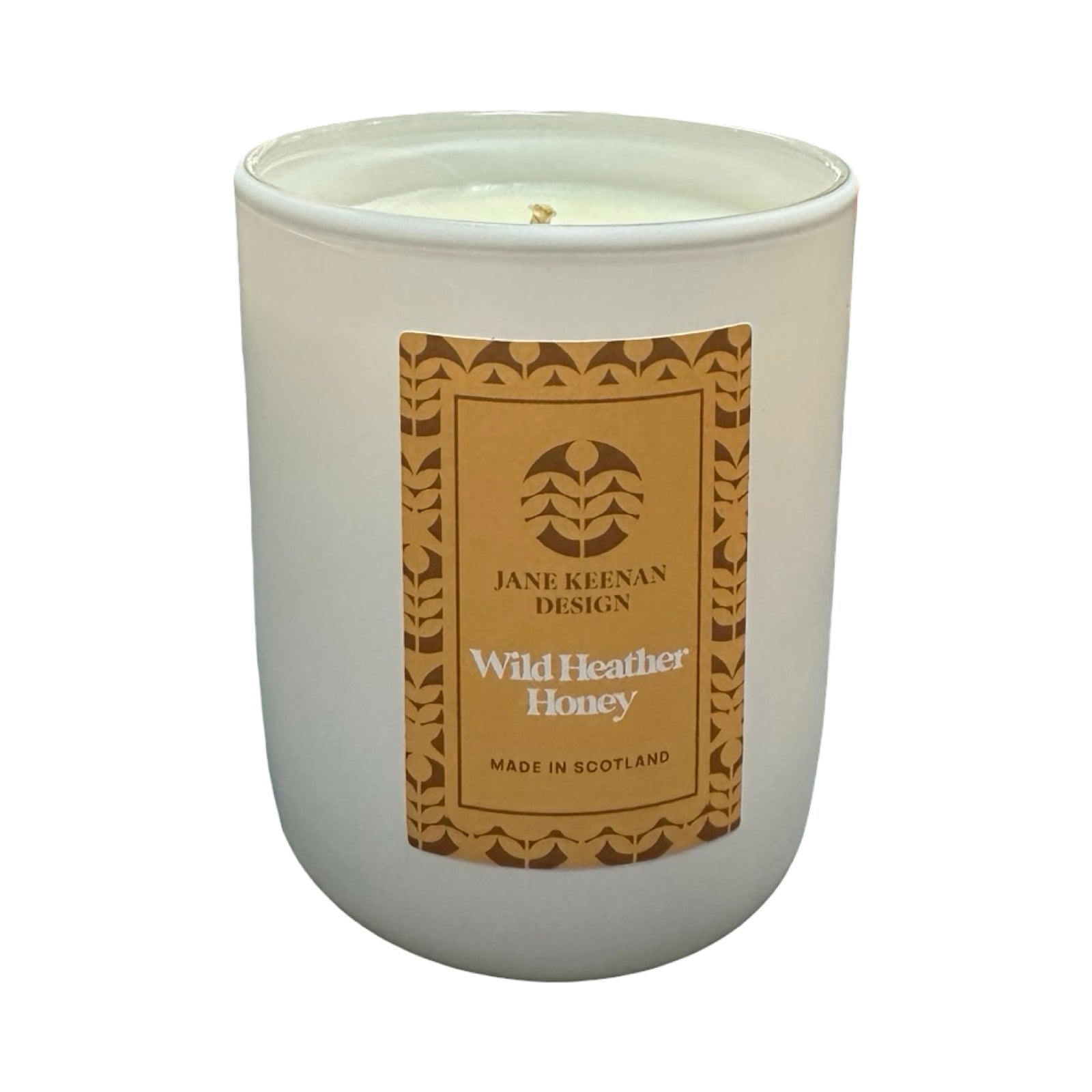 White candle in a glass jar with a brown label on a white background.