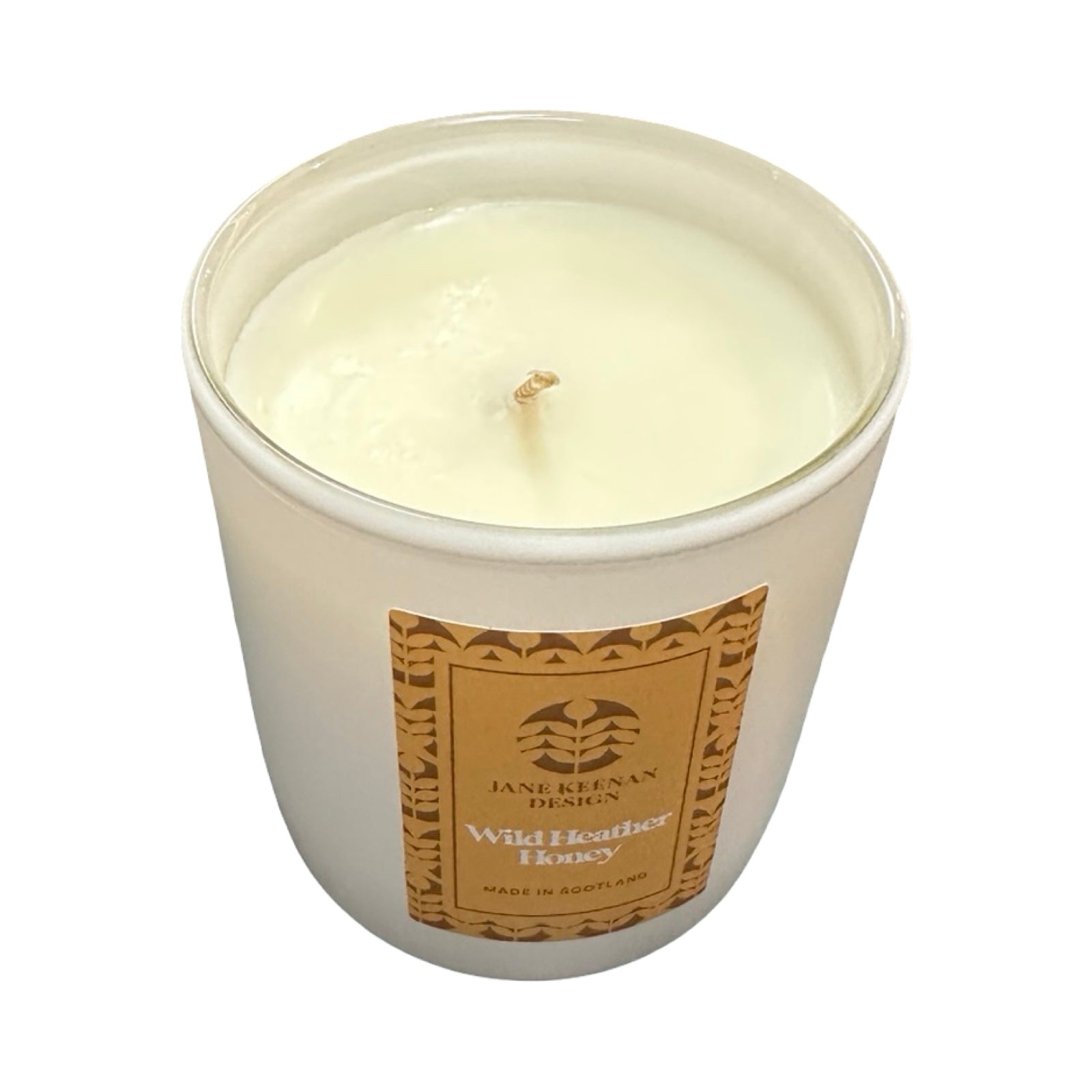 White candle in a glass jar with a brown label on a white background.