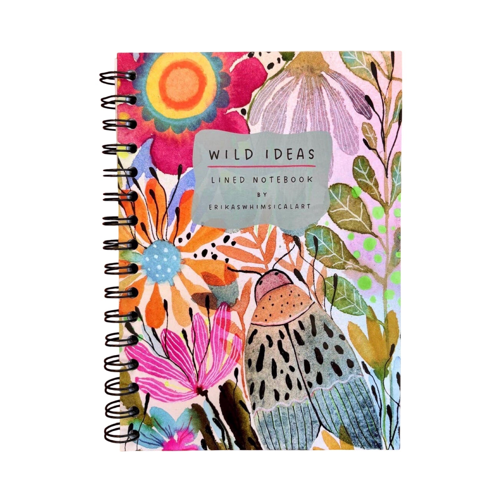 A spiral-bound lined notebook with a colourful floral and insect illustration on the cover, featuring a grey label that reads 'WILD IDEAS'.
