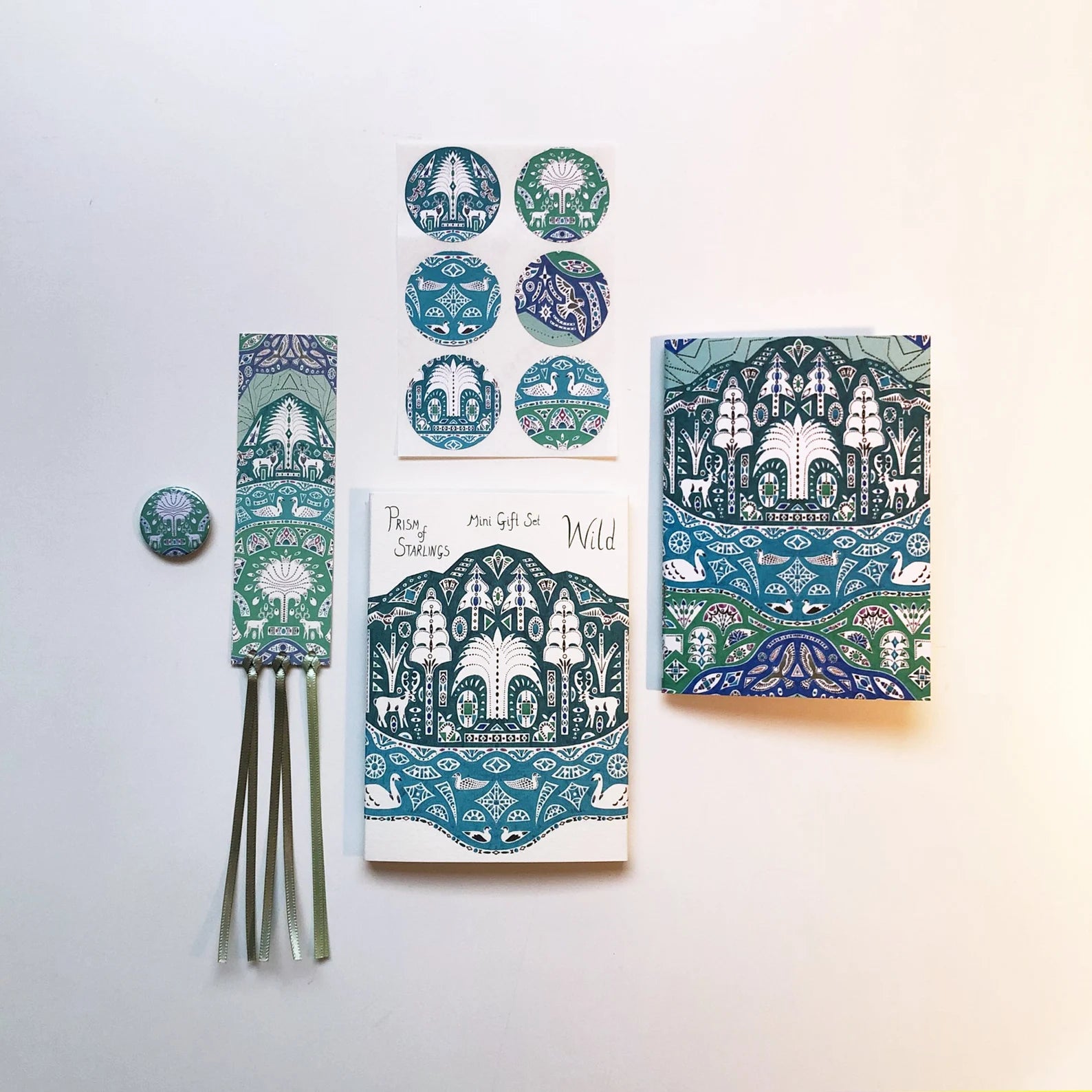 Set of stationery items with nature-themed designs on a white background.