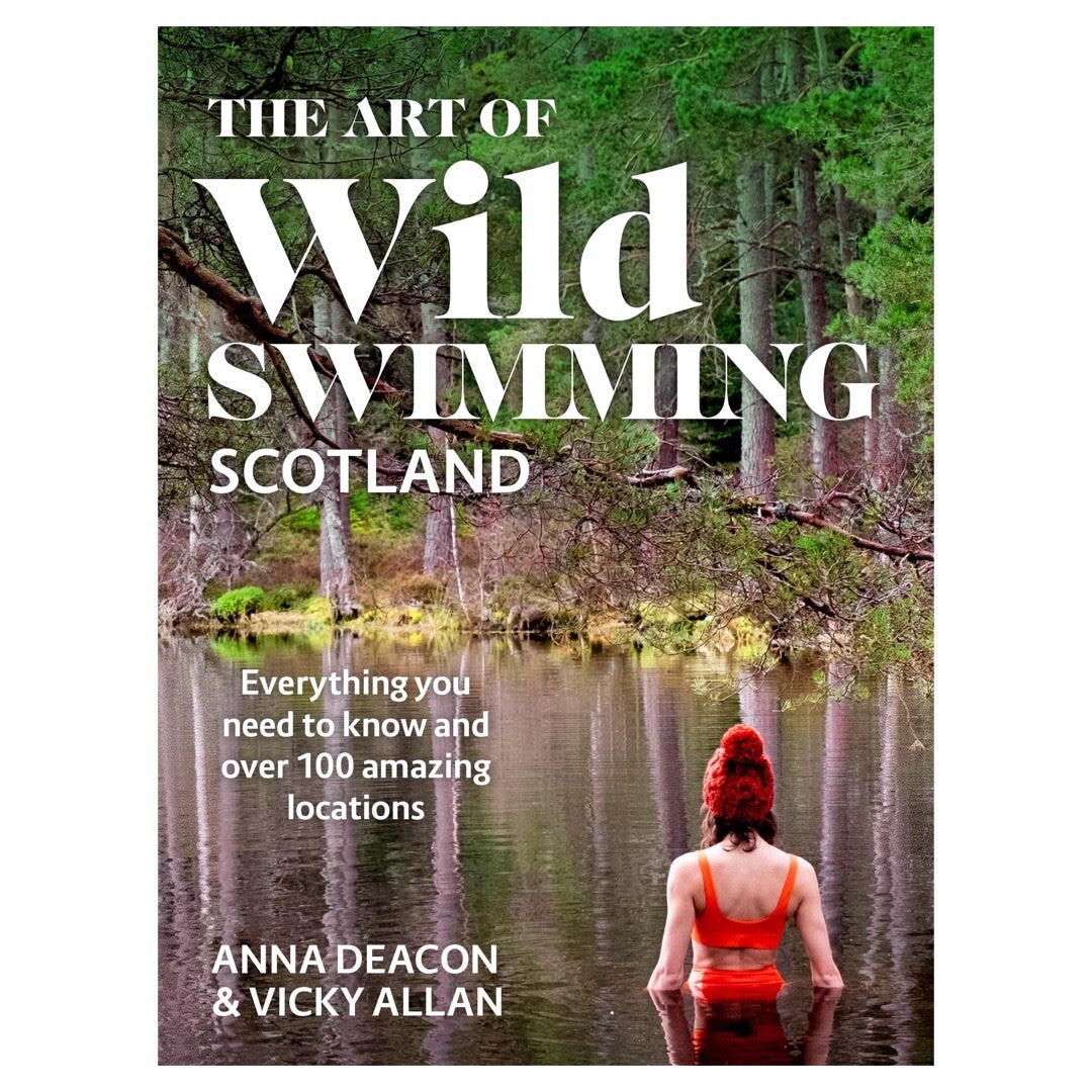 The front cover of the Wild Swimming in Scotland book showing a lady in a red wooly hat and bikini in a lake.