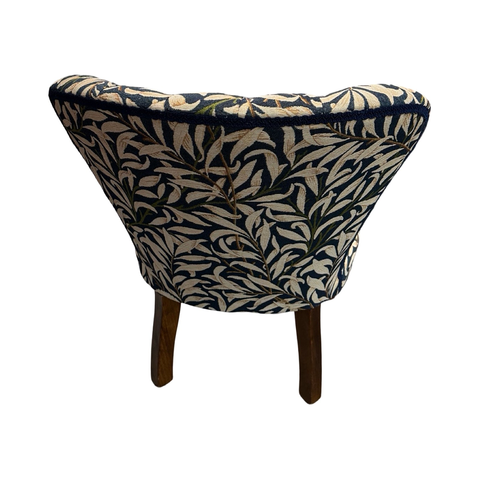 Triangular chair with leaf pattern on a white background.