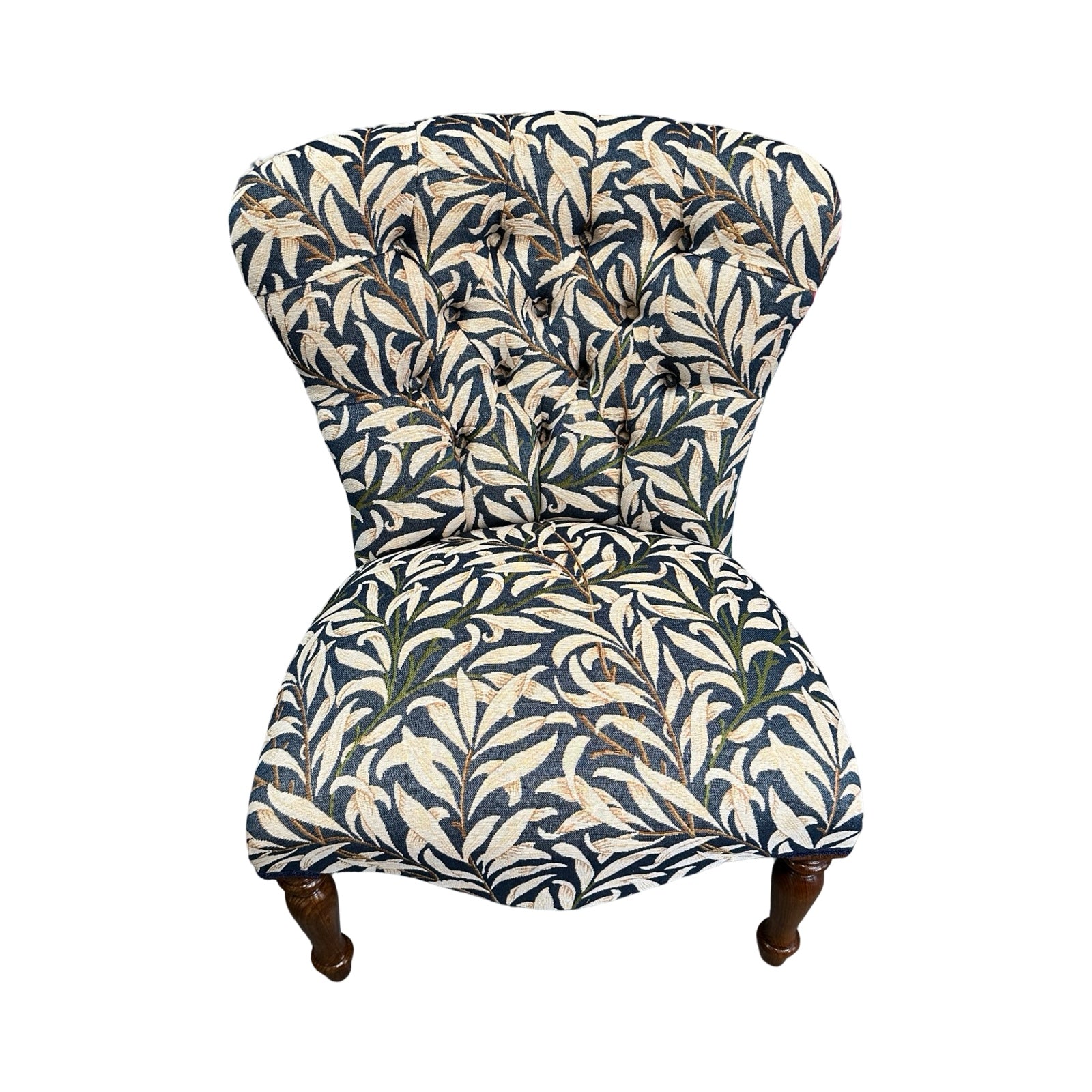 Chair with leaf pattern fabric on a white background.