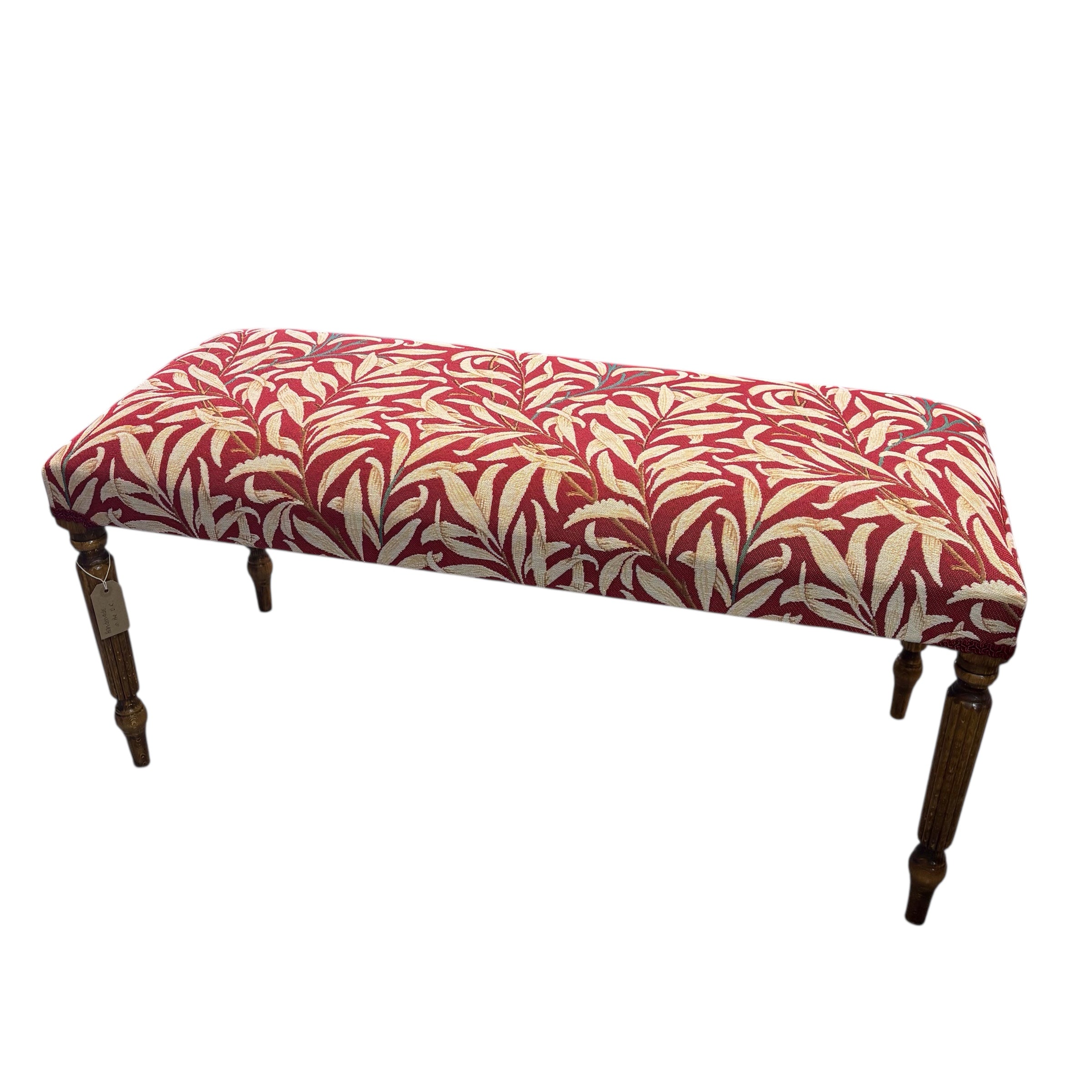 This hand-crafted rectangular bench is great for extra seating or to put your feet up on and relax. It is covered in beautiful William Morris Willow Bough tapestry-style fabric in dark red and cream. It is finished with navy blue binding and has mahogany-stained wooden legs.