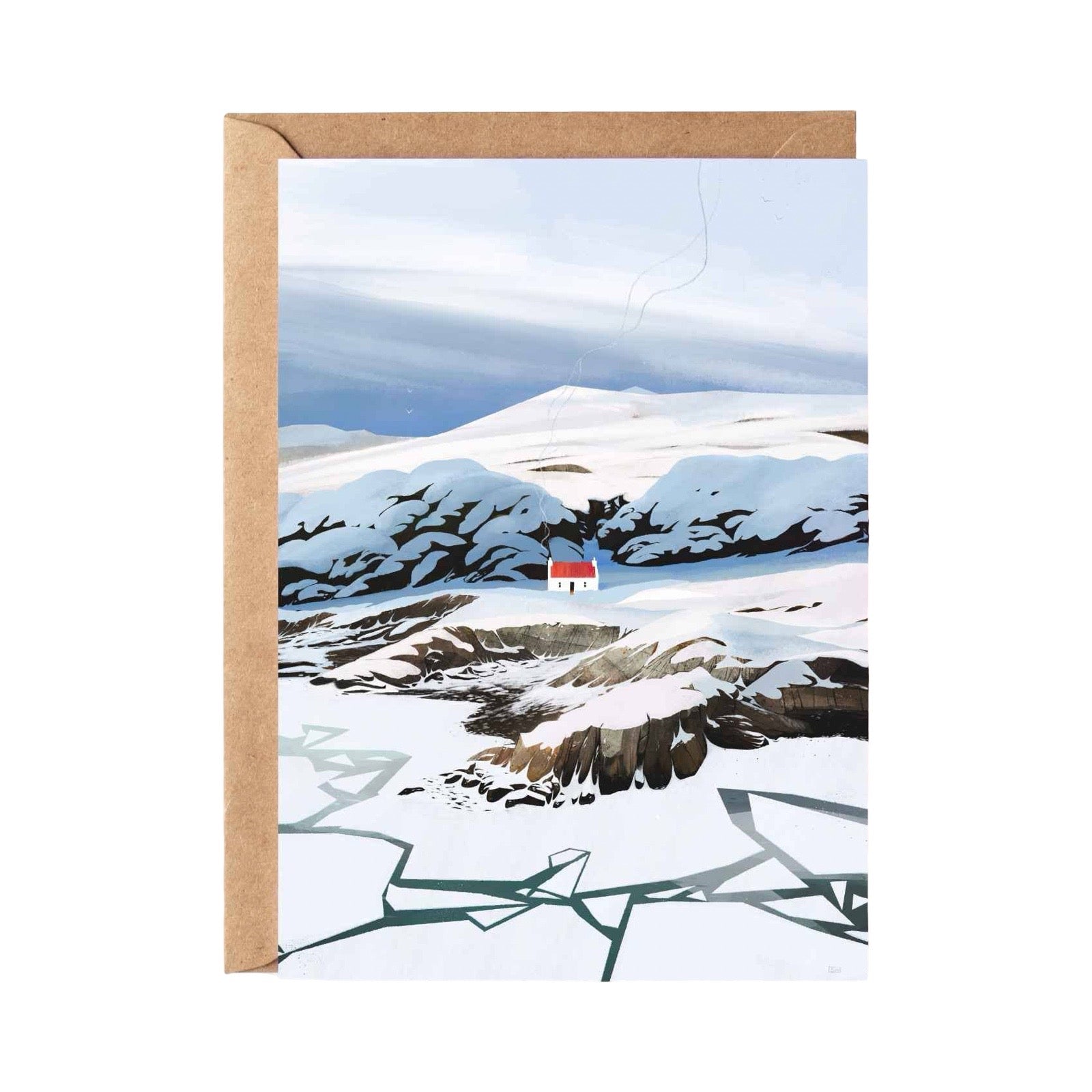 A greeting card with a brown kraft envelope, featuring an illustration of a snowy mountain landscape with a tiny red and white house in the distance.