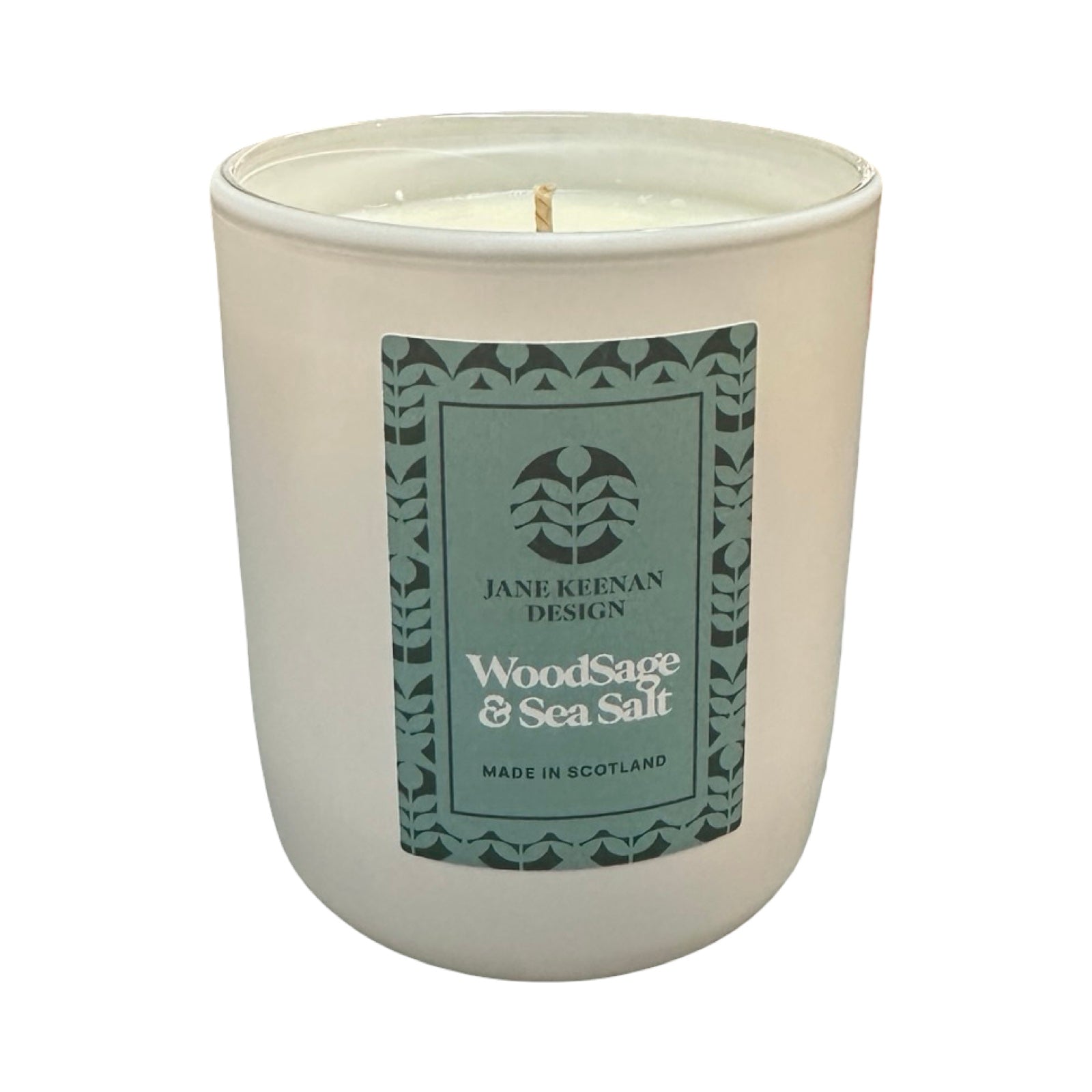 Candle with a green label on a white background.