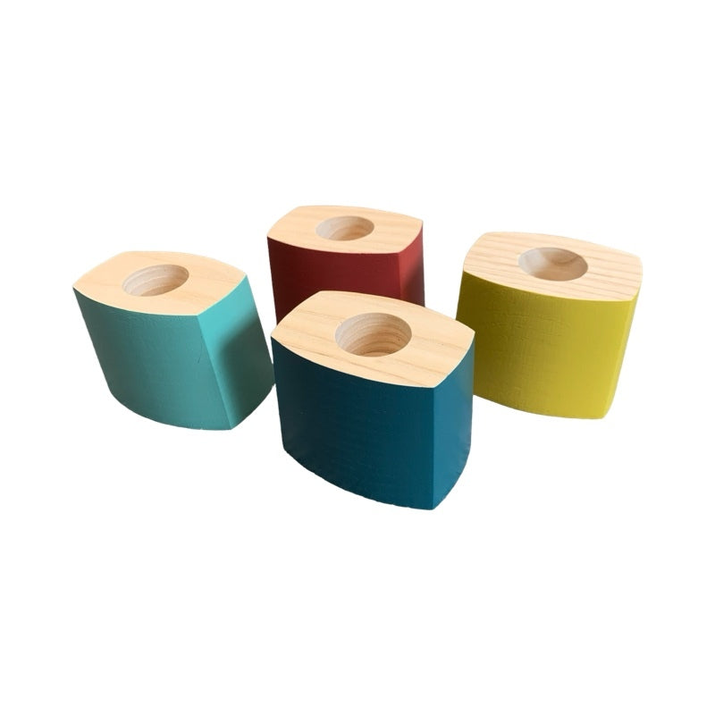 Four painted wooden dinner candle holders.