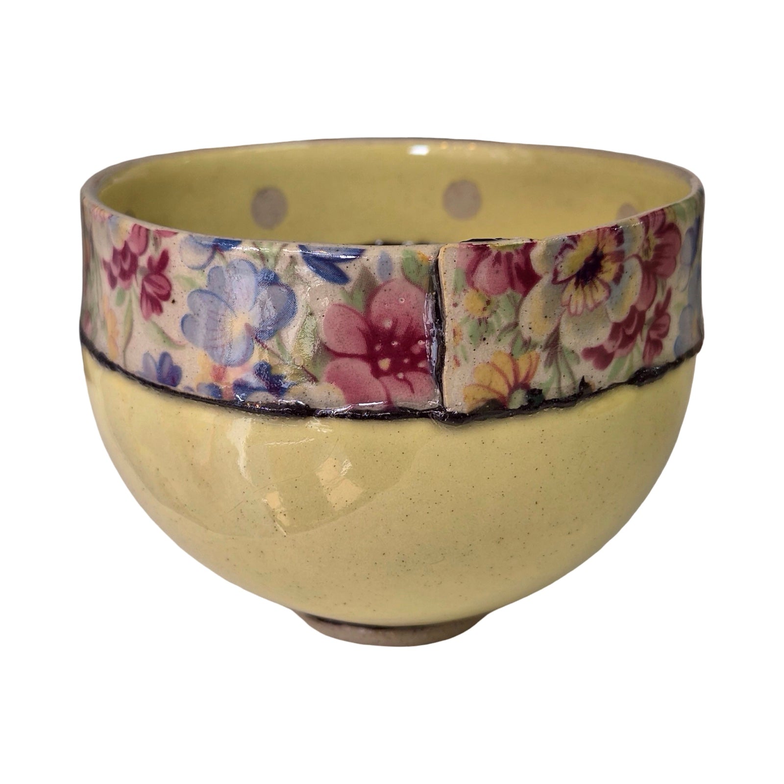 Ceramic bowl with floral patterned band on a white background.