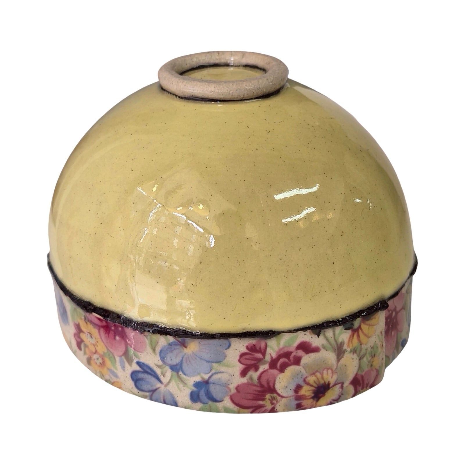 Round upside down ceramic bowl with floral design on a white background.