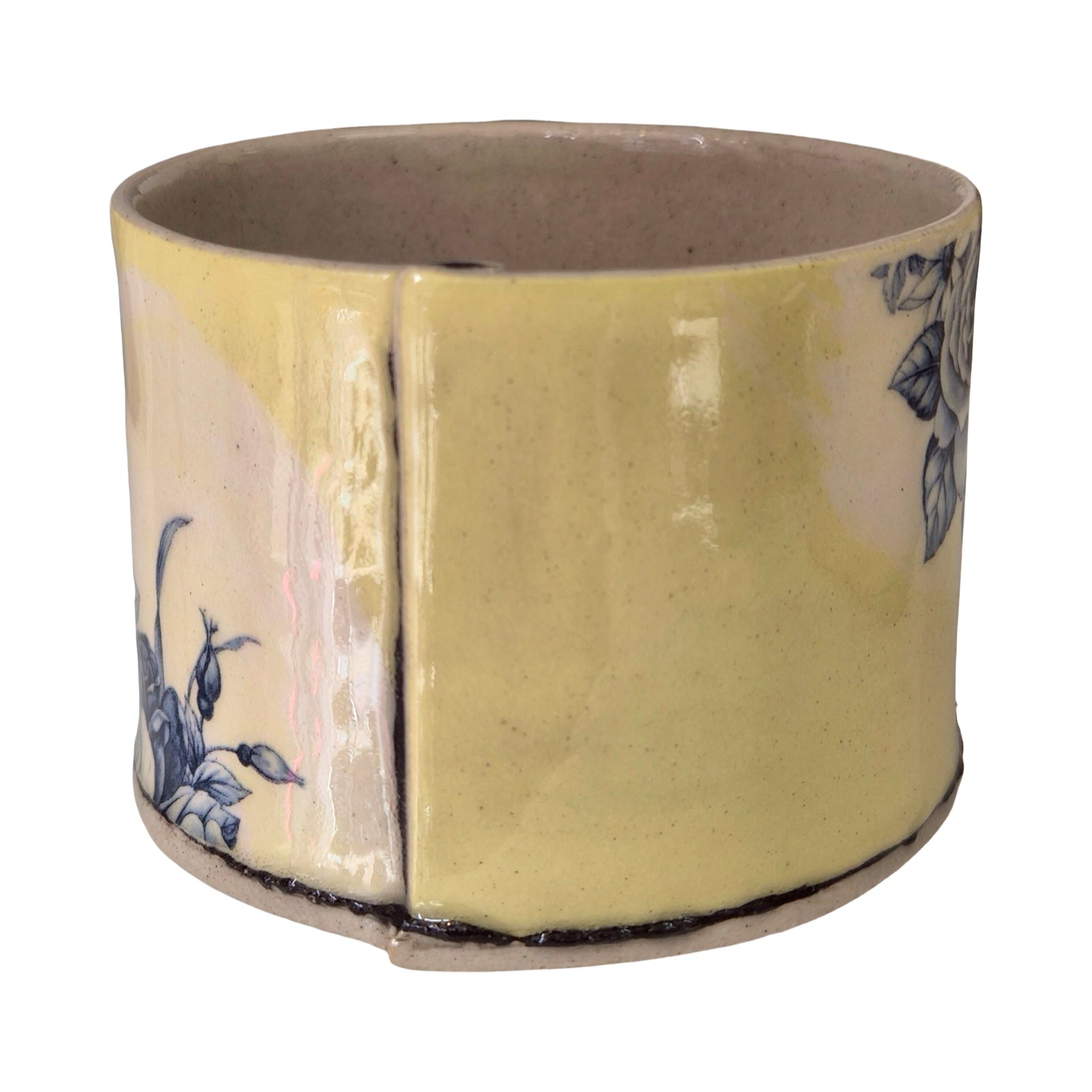Ceramic planter with floral design on a white background.